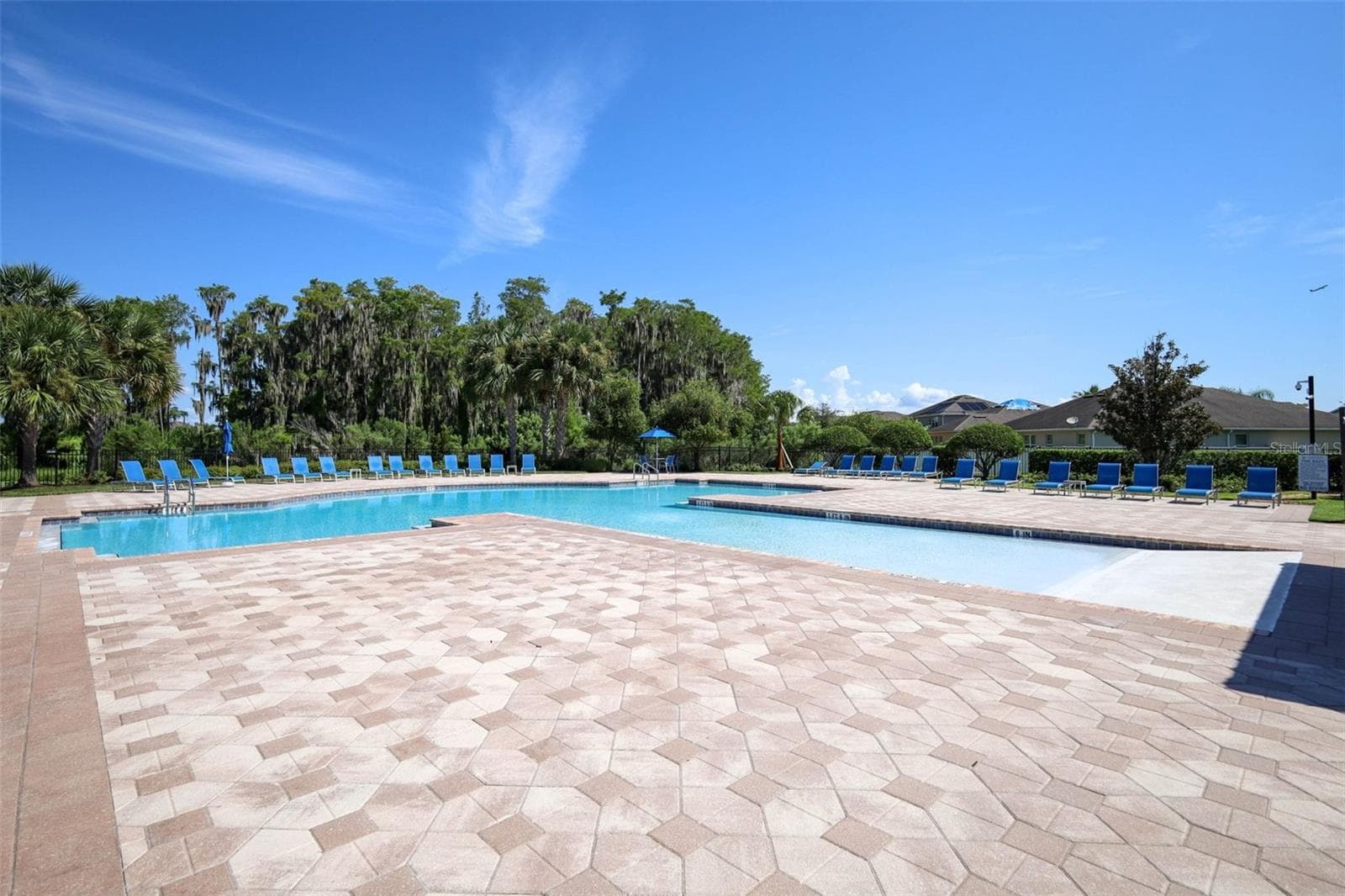 Scenic view of the sparkling pool and patio area, perfect for relaxing - 12397 STONE BARK TRL, ORLANDO