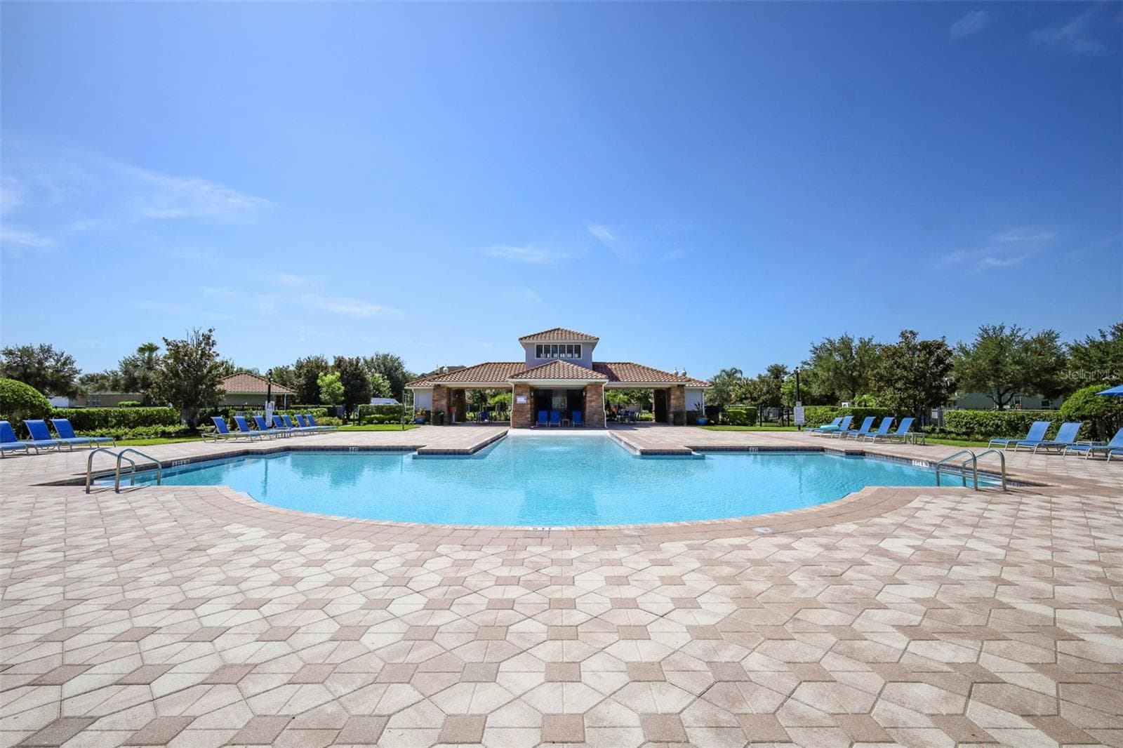 Scenic view of the sparkling pool and patio area, perfect for relaxing - 12397 STONE BARK TRL, ORLANDO