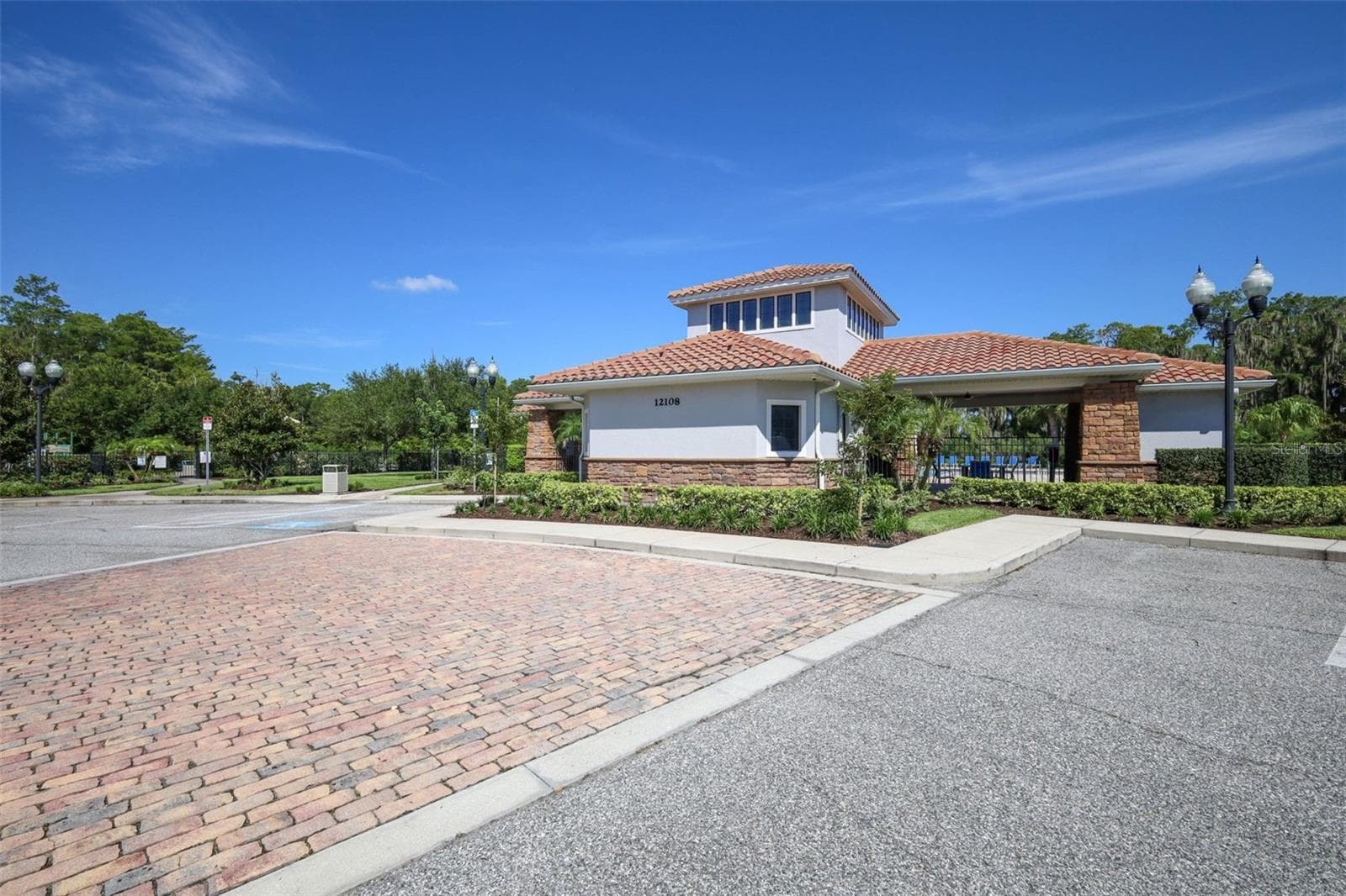 Clubhouse, pool area, and parking spaces. - 12397 STONE BARK TRL, ORLANDO