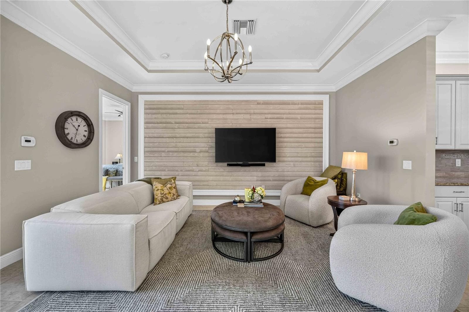 Living room has multiple architectural details - shiplap feature wall, 9" crown molding - 24232 GALLBERRY DR, VENICE
