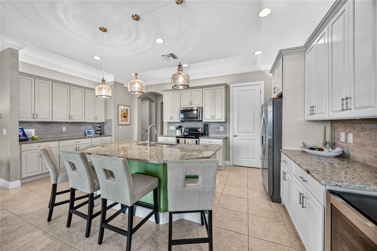 Light cabinets and granite, fabulous lighting, large kitchen with multiple cabinets and counters.  Island for dining. - 24232 GALLBERRY DR, VENICE