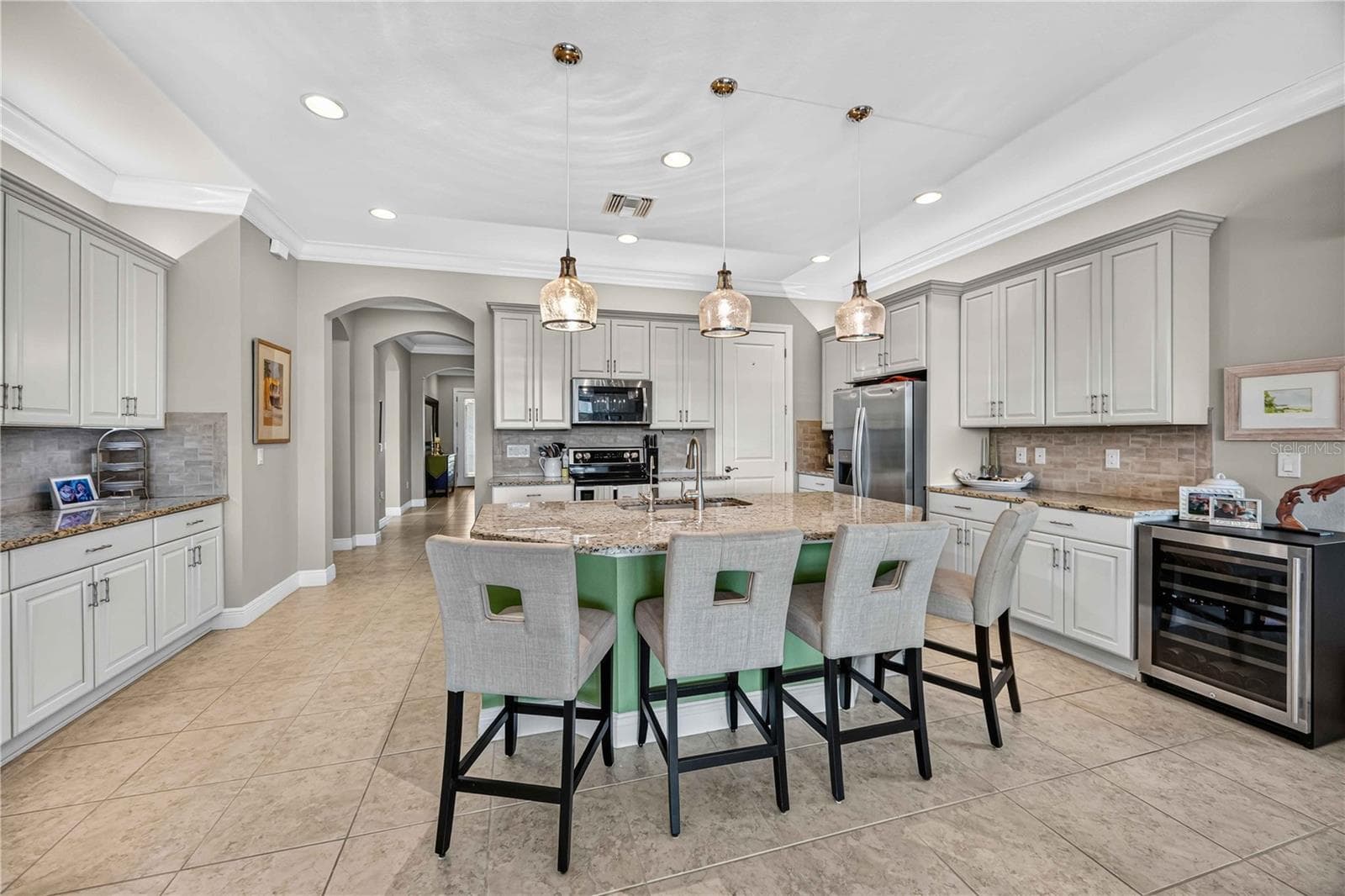Light cabinets and granite, fabulous lighting, large kitchen with multiple cabinets and counters.  Island for dining. - 24232 GALLBERRY DR, VENICE