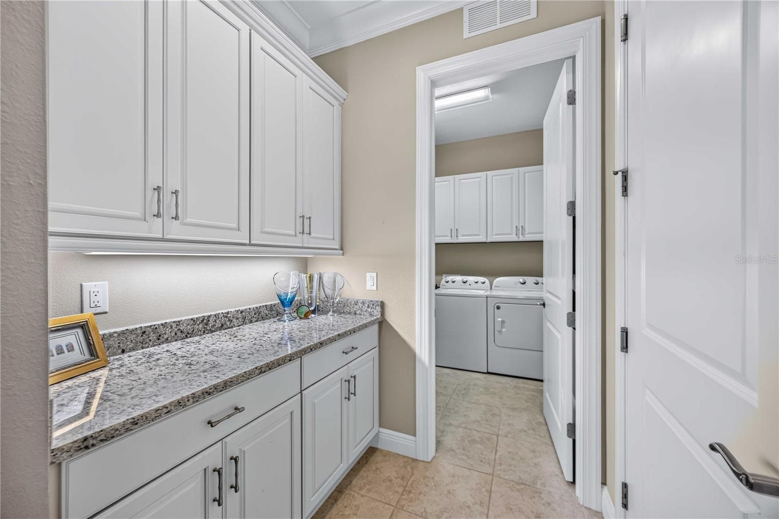 The drop zone off the garage and laundry room is fabulous for in and out organization. - 24232 GALLBERRY DR, VENICE