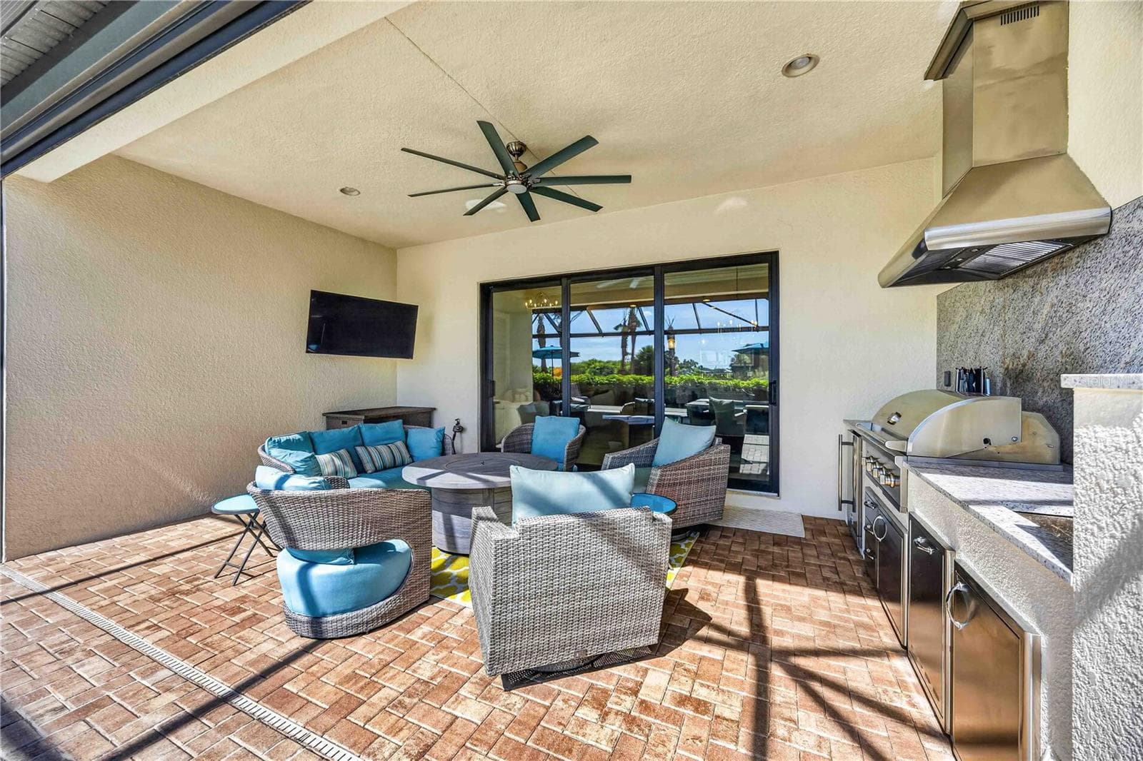 The lanai features a stunning outdoor kitchenand outdoor space to entertain - 24232 GALLBERRY DR, VENICE