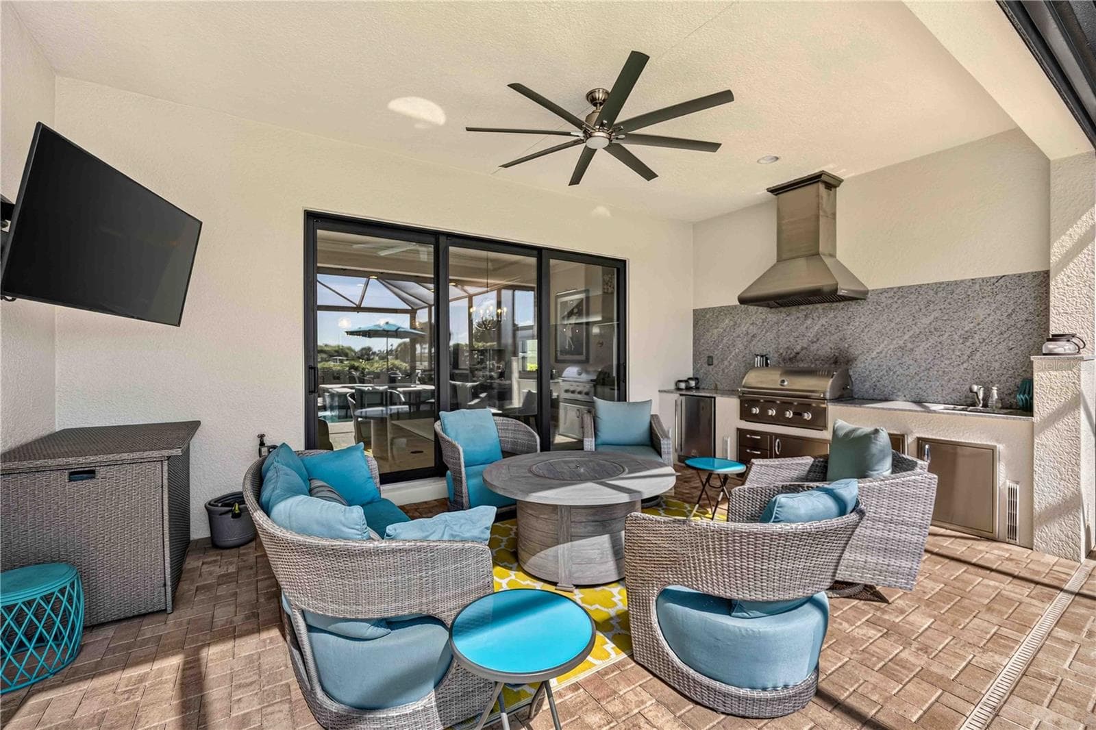 The lanai features a stunning outdoor kitchen and outdoor space to entertain - 24232 GALLBERRY DR, VENICE