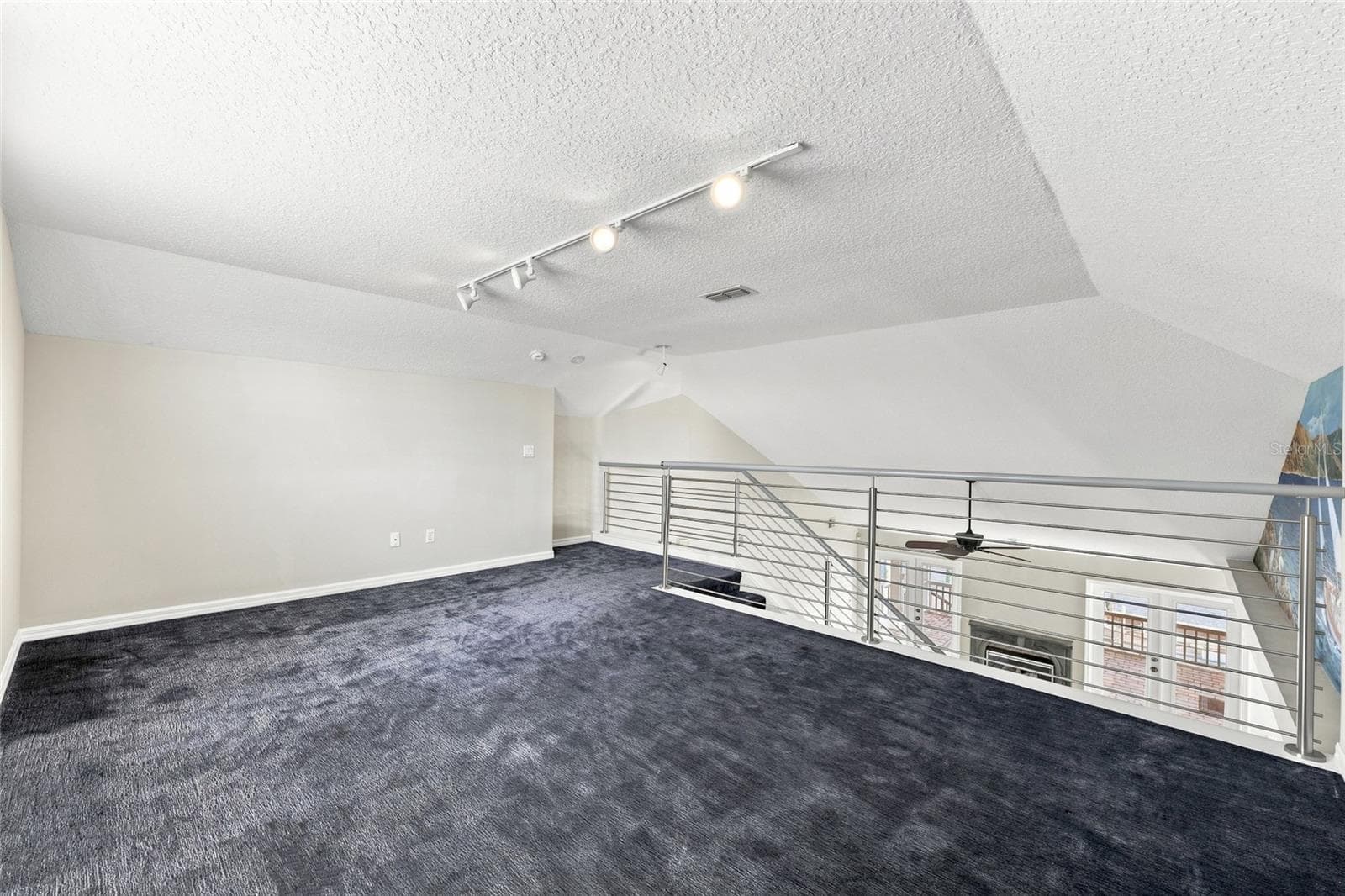 Loft — Loft area with cable railing overlooking the great room fireplace and French doors to the balcony below. - 342 N 12TH ST, FLAGLER BEACH
