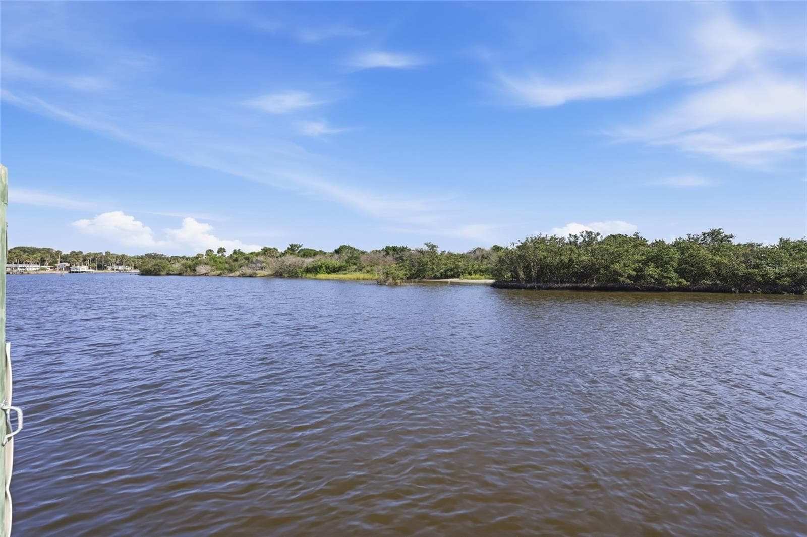 Canal view — Wide canal view from the dock showing the natural mangrove shoreline and open water leading toward the Intracoastal Waterway. - 342 N 12TH ST, FLAGLER BEACH