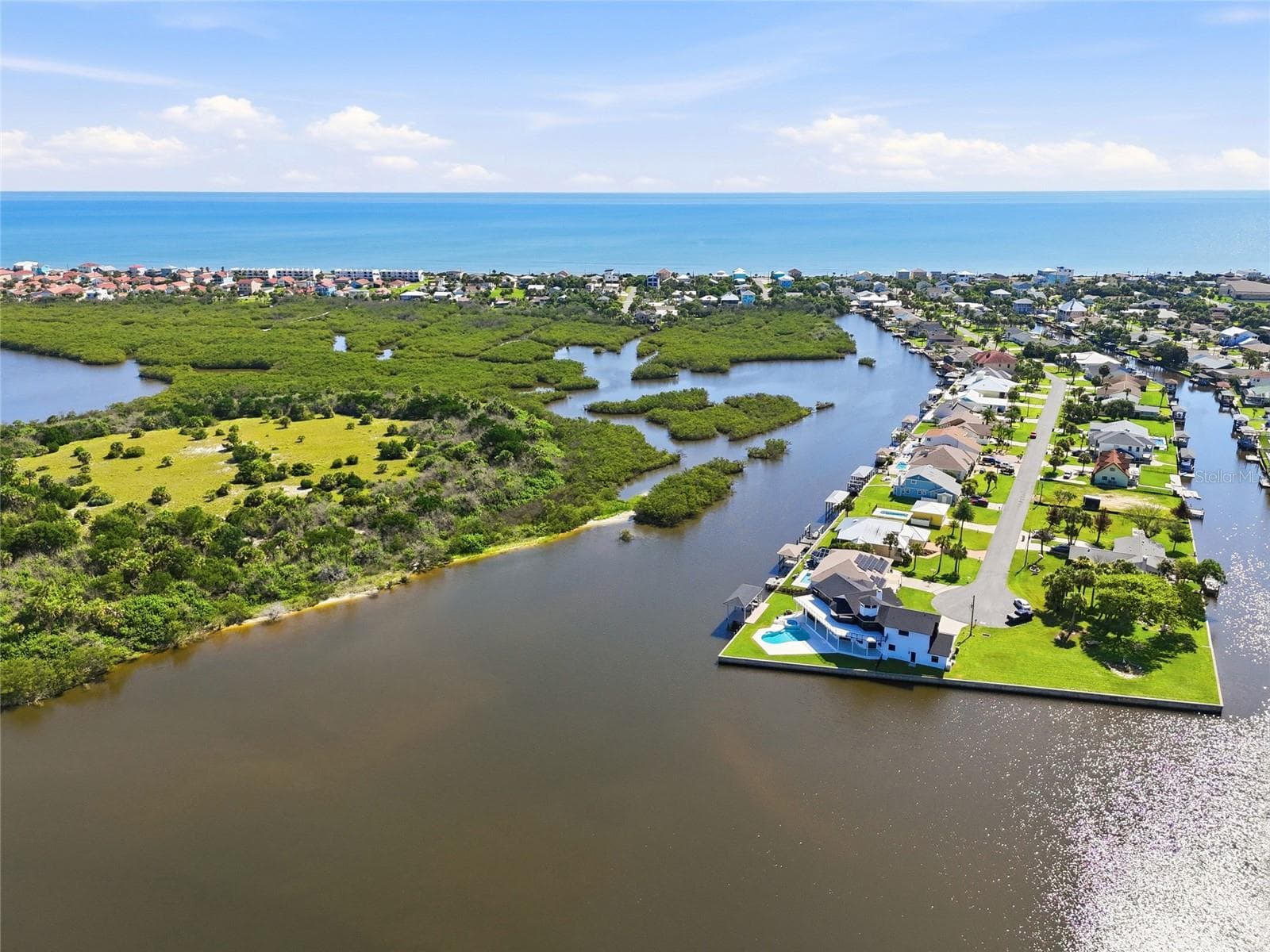 Aerial view — Panoramic aerial view of the canal-front community, marsh islands, and Atlantic Ocean shoreline in the distance. - 342 N 12TH ST, FLAGLER BEACH