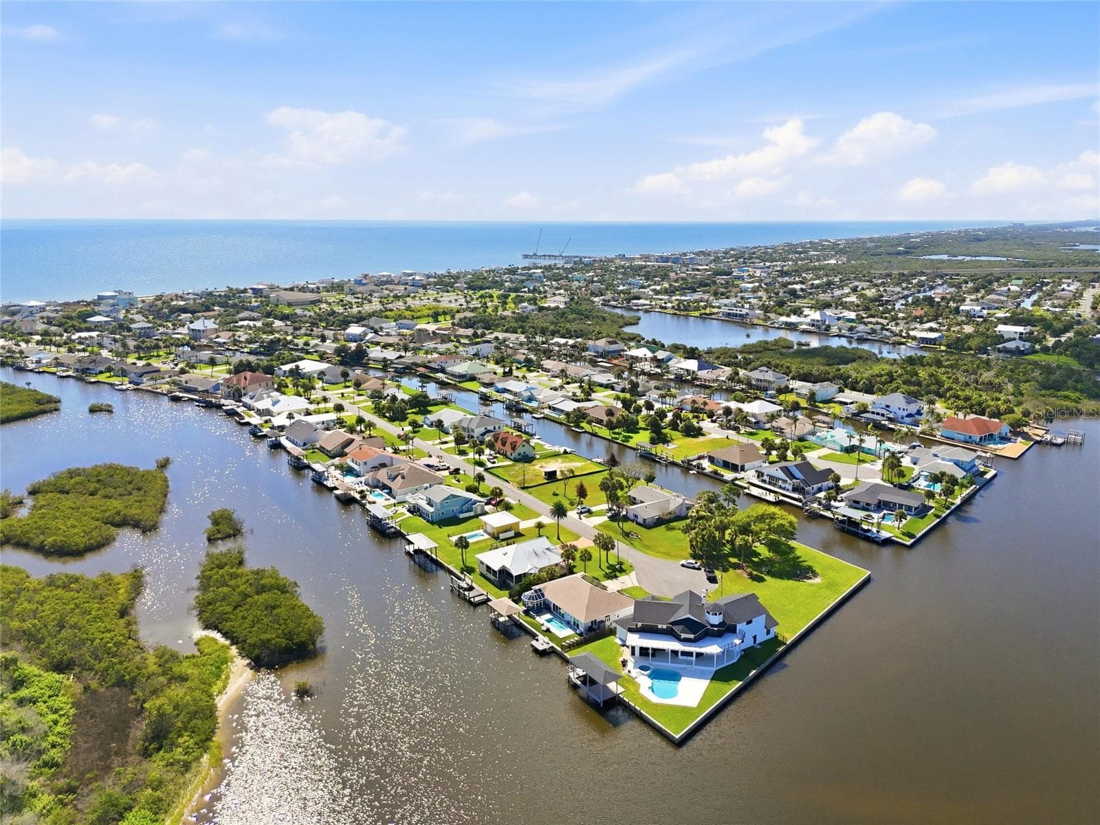 Aerial view — Aerial view of the canal and surrounding waterfront homes, matching the marked view of the property's location. - 342 N 12TH ST, FLAGLER BEACH