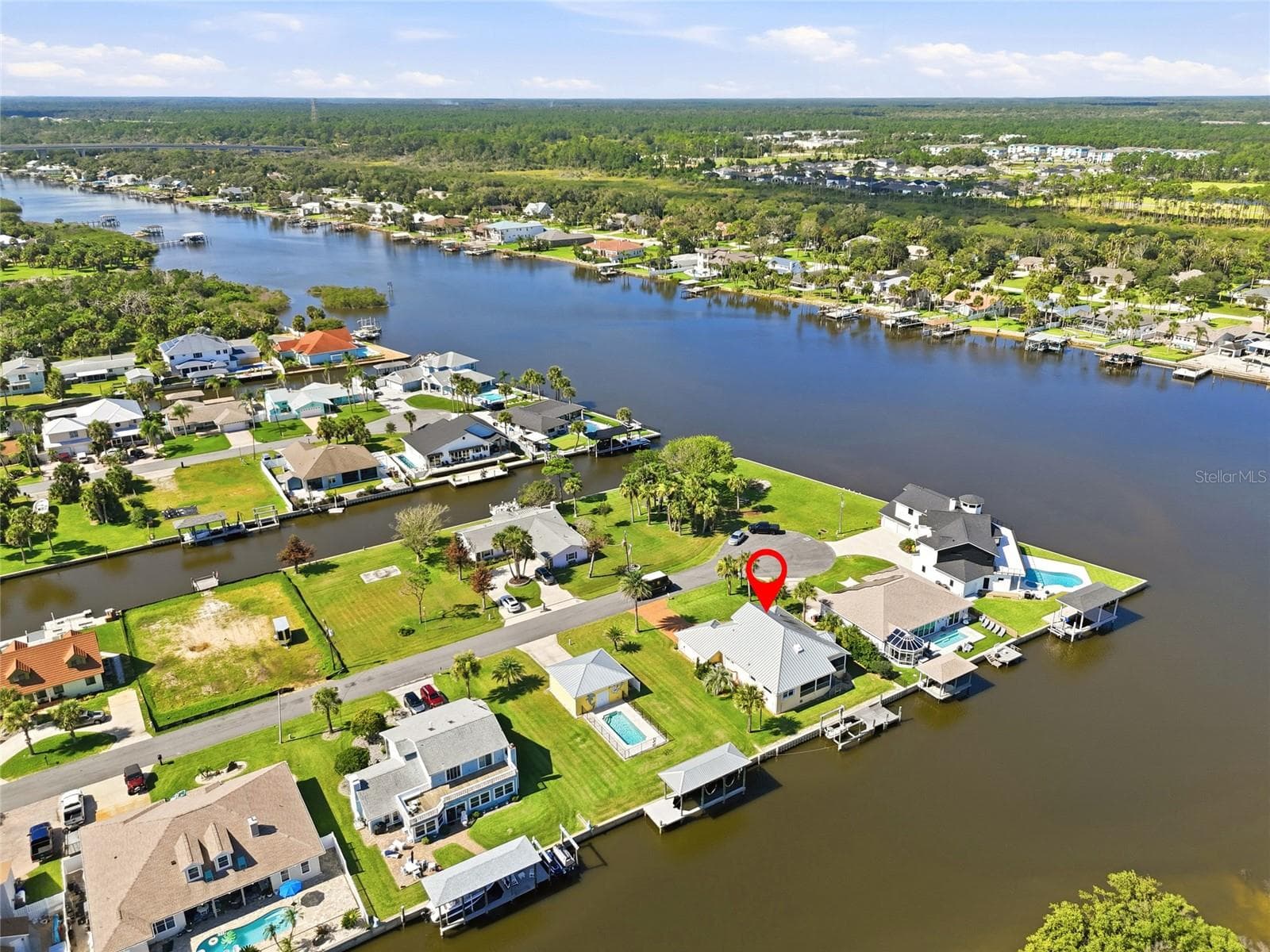 Aerial view (marked) — Aerial view with the property marked, showing its position on the canal with direct water access toward the Intracoastal Waterway and Atlantic Ocean. - 342 N 12TH ST, FLAGLER BEACH
