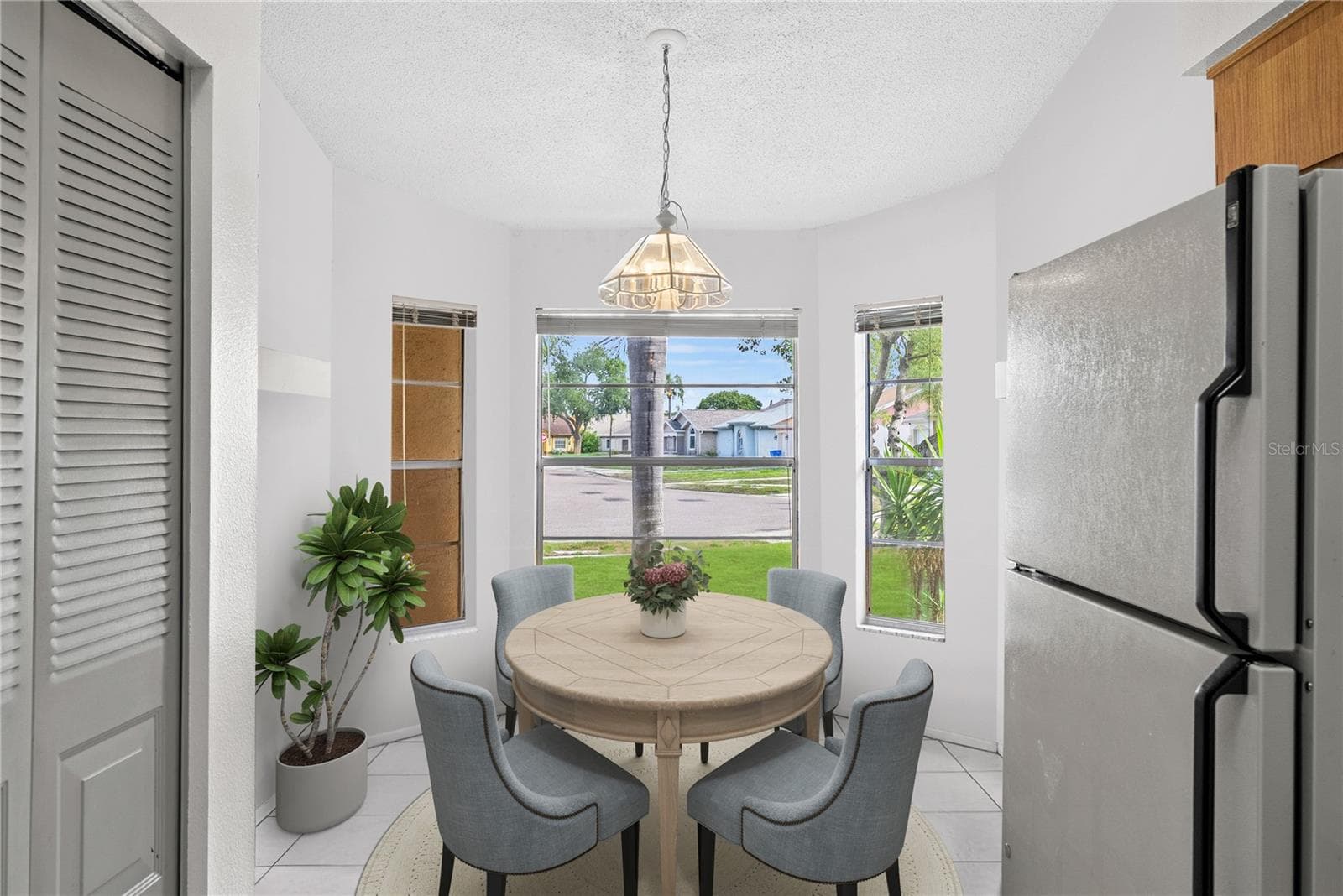 Kitchen staged with neutral colors and modern furniture - 8601 TWIN FARMS PL, TAMPA