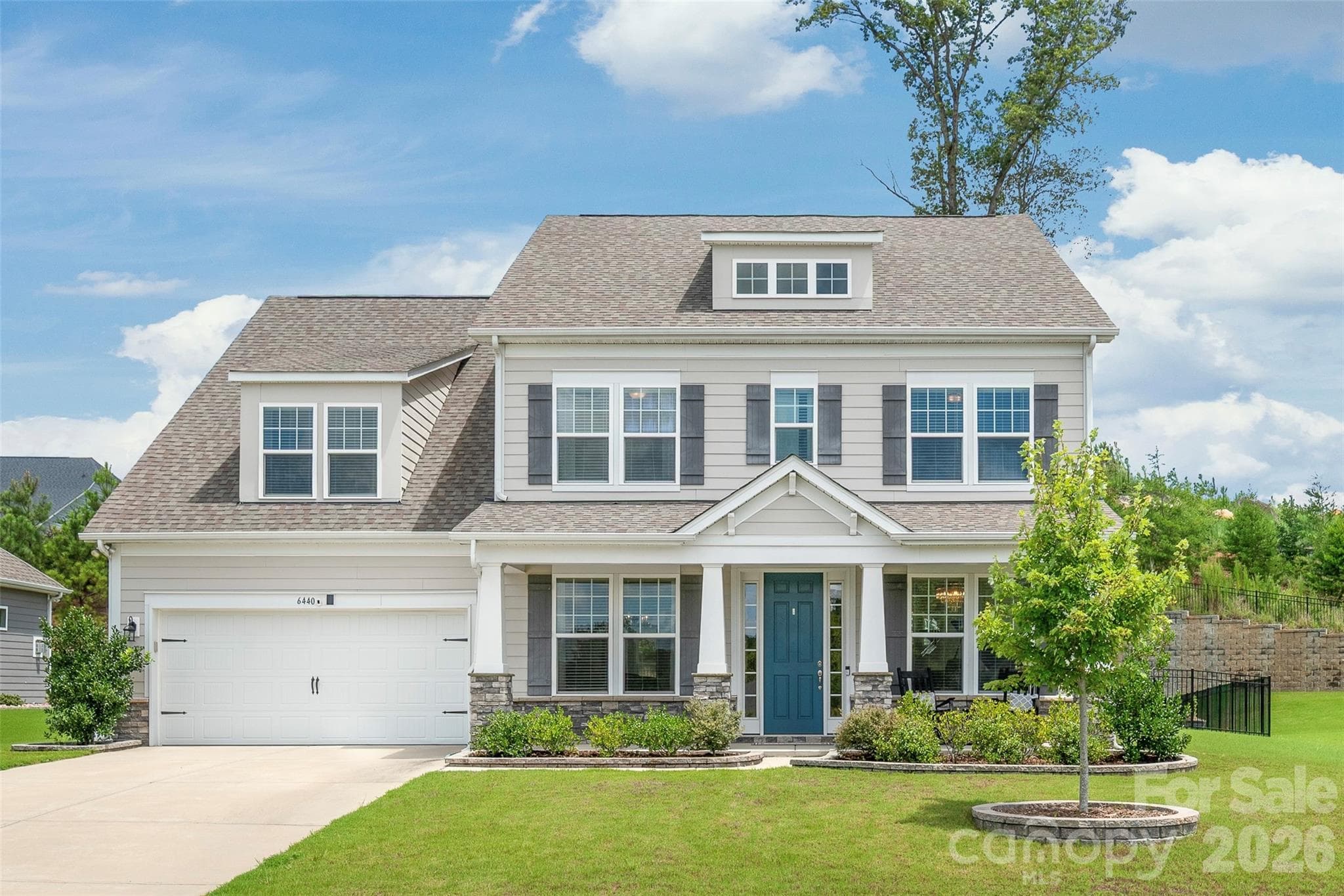 A charming covered porch welcomes you to this stunning Arts and Crafts exterior, blending timeless architectural character with exceptional curb appeal. - 6440 Ancient Way, Fort Mill