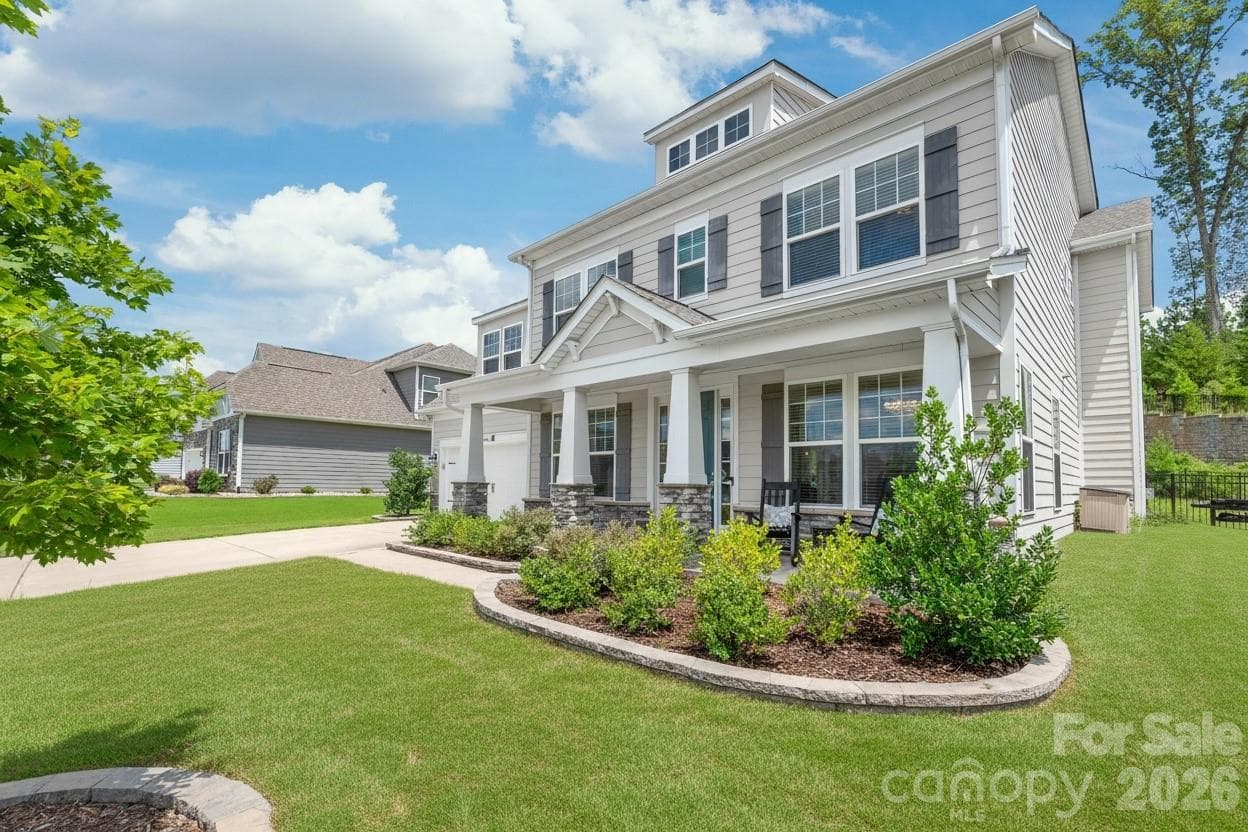 Crafted for lasting durability and timeless beauty, the exterior features low-maintenance cement siding anchored by striking stone accent columns. - 6440 Ancient Way, Fort Mill