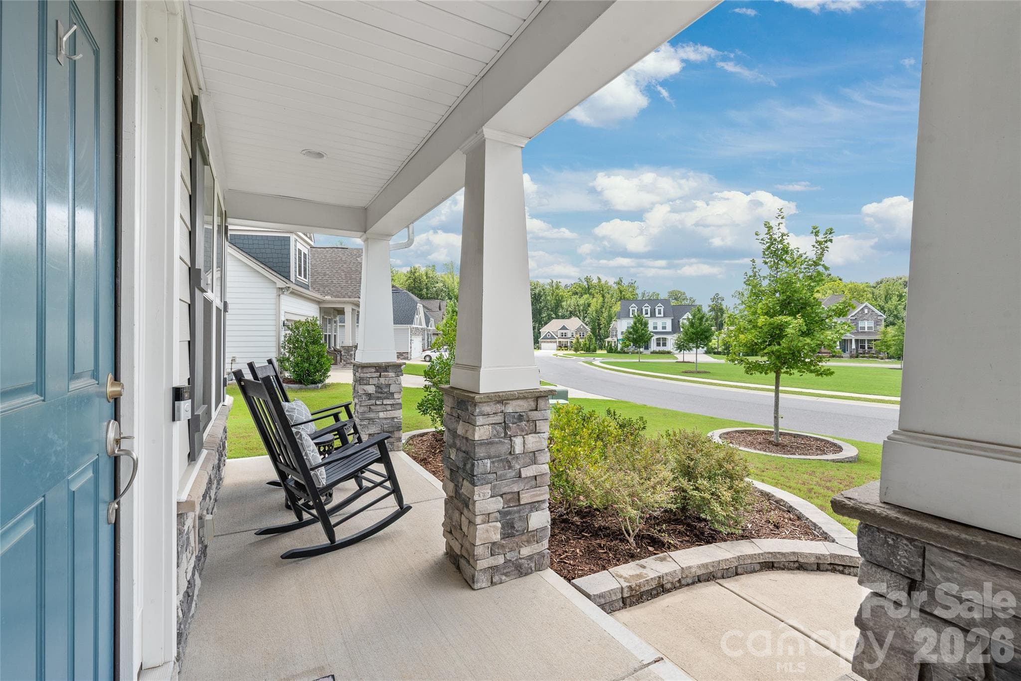 Unwind on the inviting covered porch, the perfect spot to sip your morning coffee or relax and watch the world go by. - 6440 Ancient Way, Fort Mill