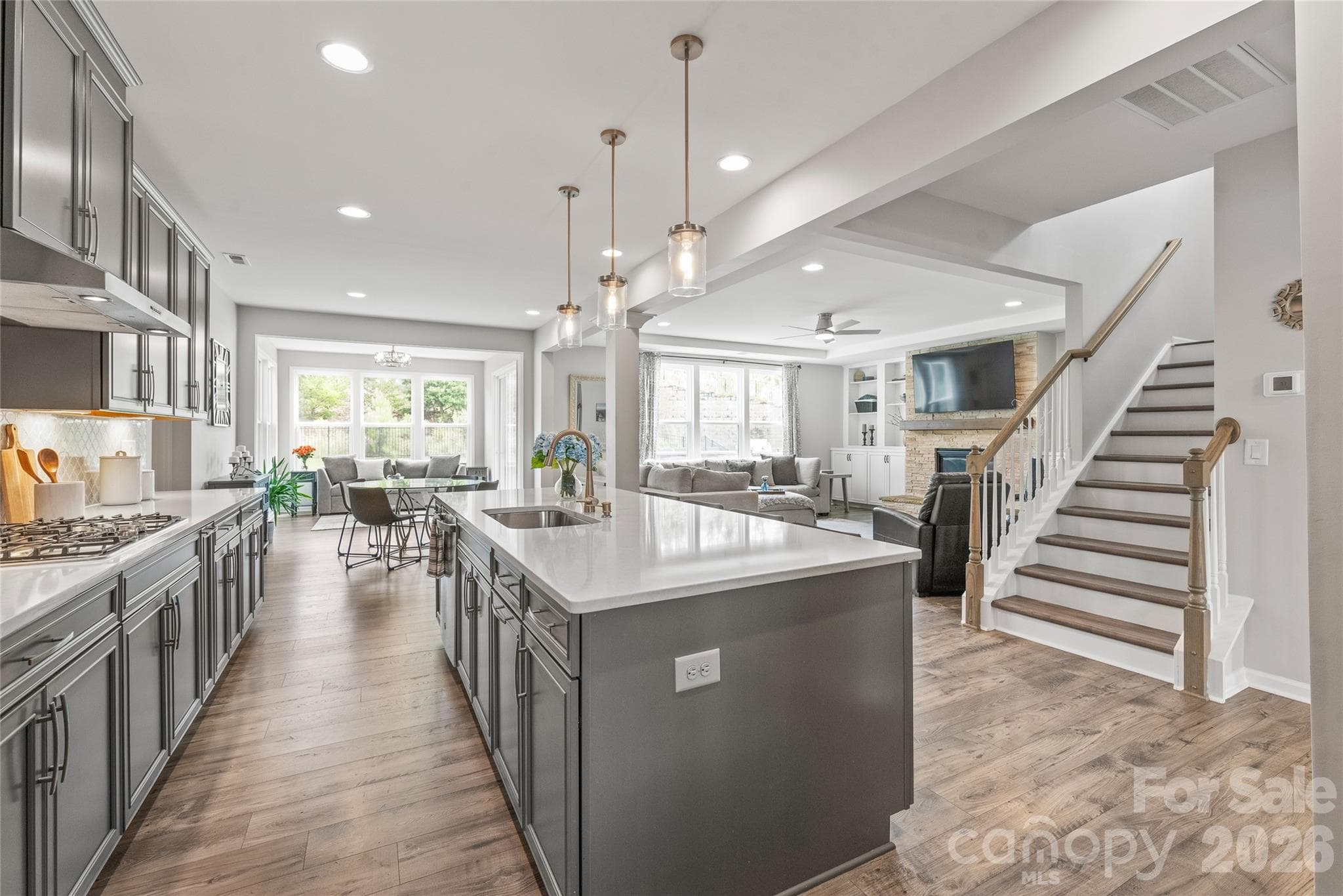The ultimate open-concept layout...the kitchen connects seamlessly to the sunlit breakfast area, cozy living room, and cheerful sunroom for effortless everyday living and entertaining. - 6440 Ancient Way, Fort Mill