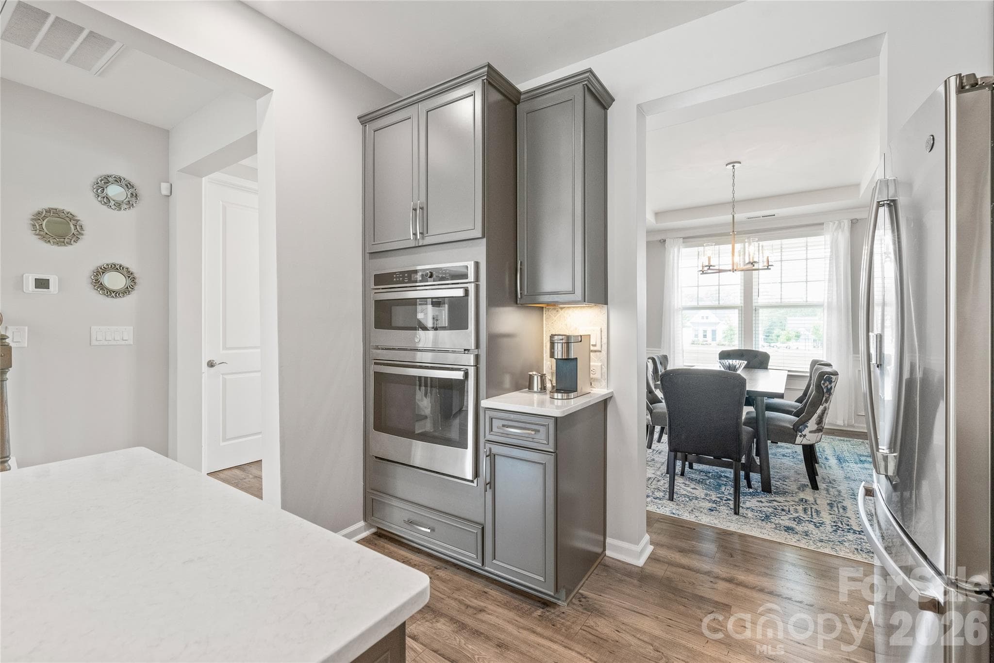 Sleek built-in microwave and wall oven units deliver a streamlined, professional look while keeping counter space completely clear for prep. - 6440 Ancient Way, Fort Mill