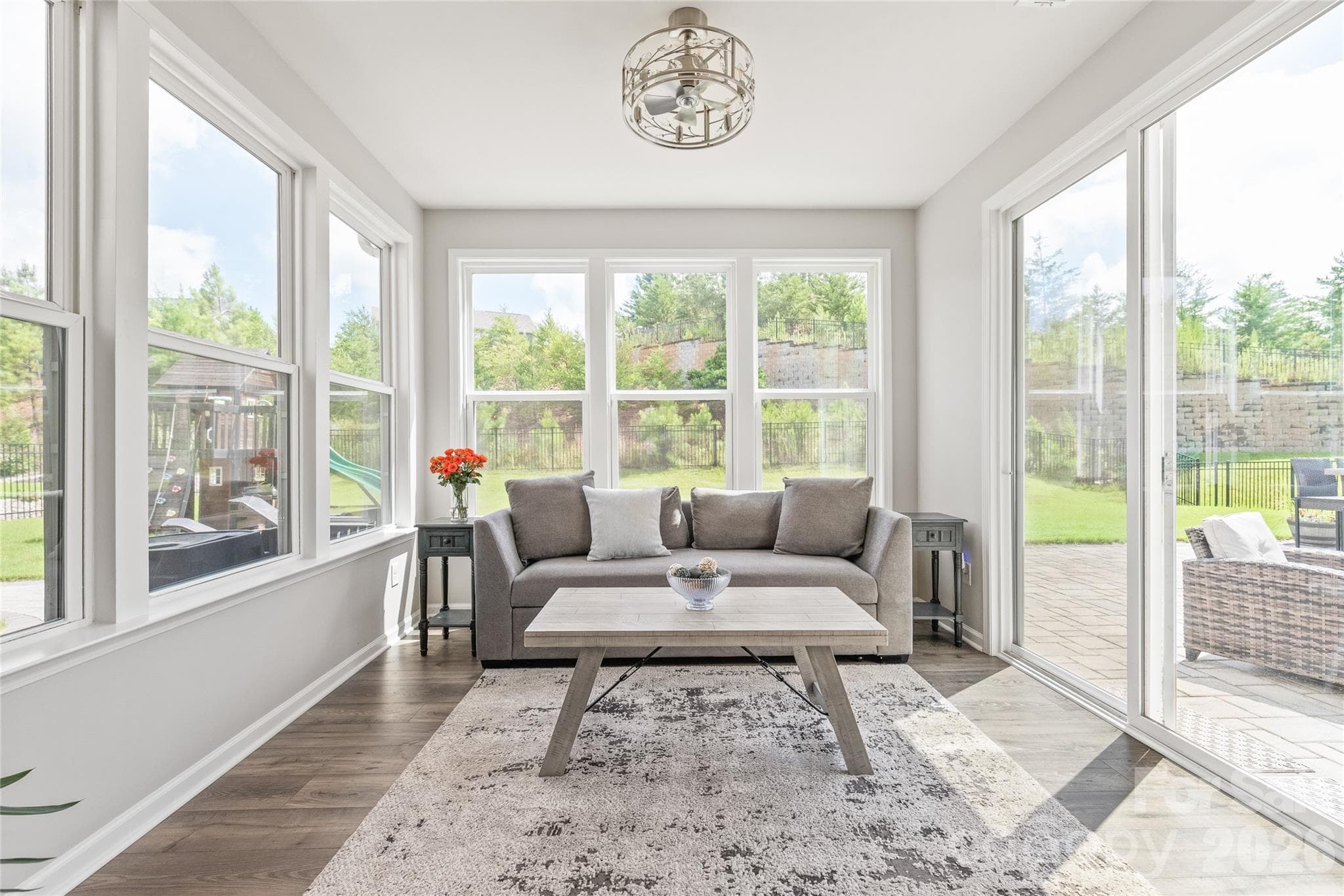 Featuring a modern fandelier, this sun-drenched space opens directly out to your private backyard oasis. - 6440 Ancient Way, Fort Mill