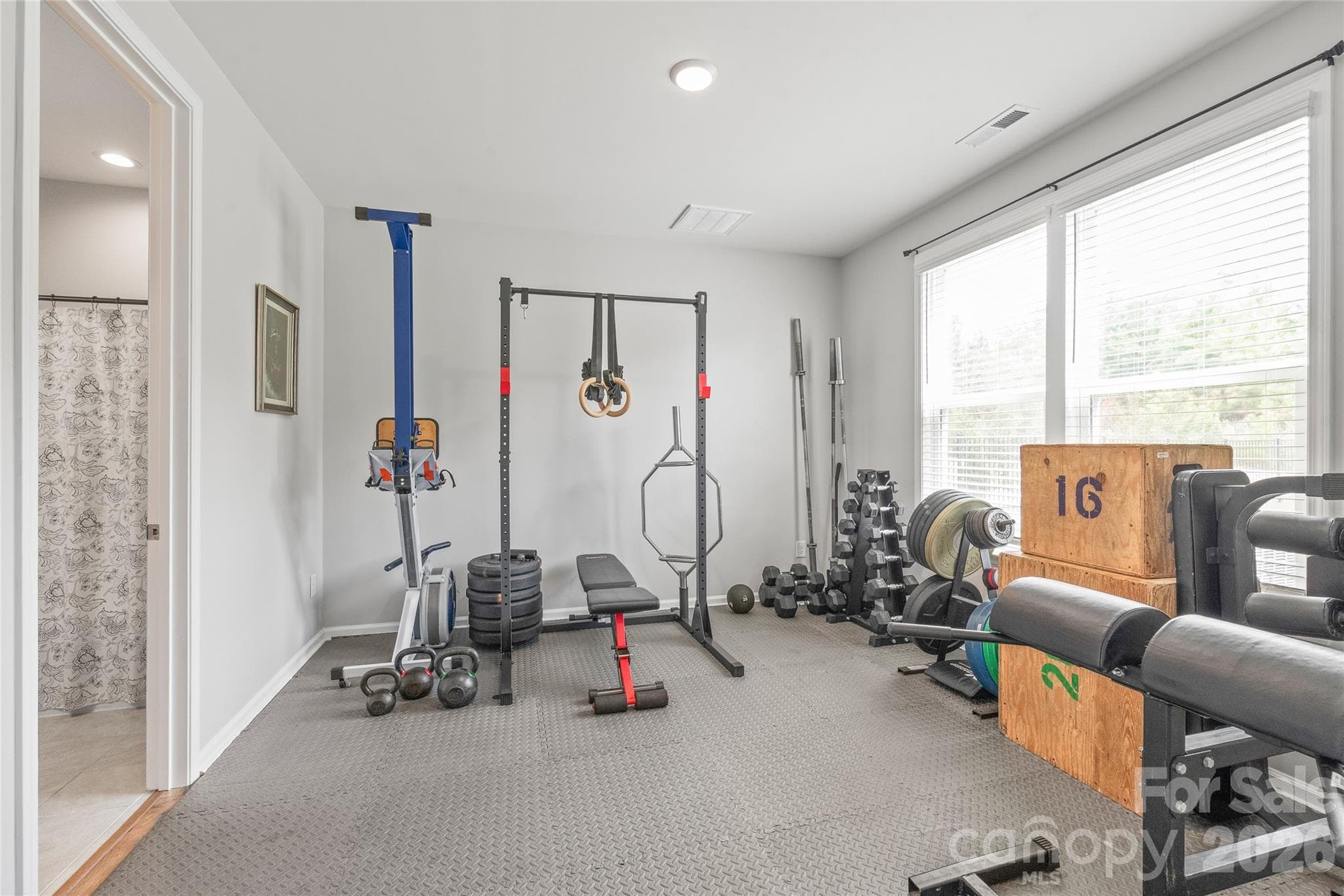Conveniently located on the main level, this spacious guest bedroom offers complete privacy and access to its own private full bathroom, making it ideal for visitors, multi-generational living, or even a home gym. - 6440 Ancient Way, Fort Mill