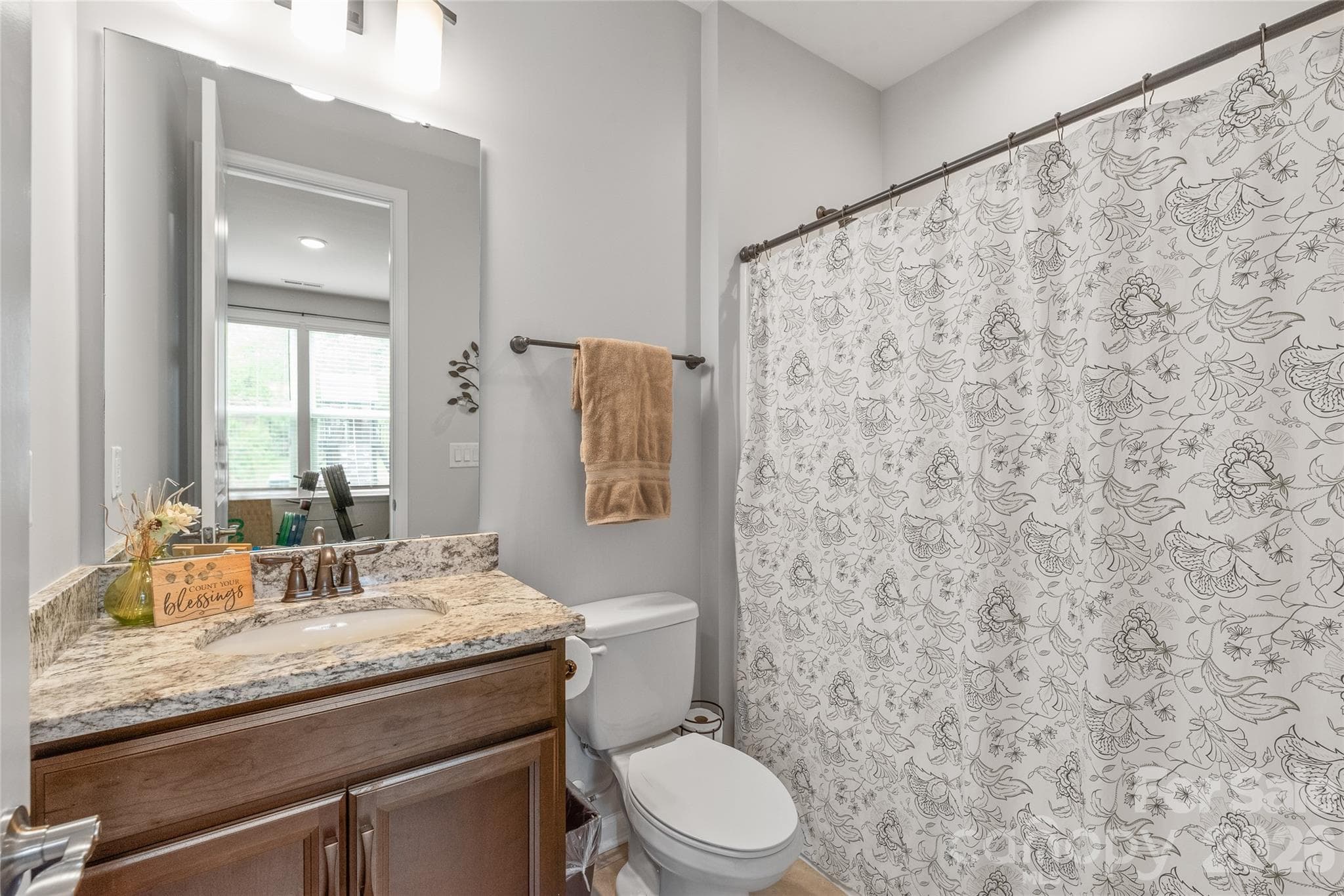 Dedicated to the main-floor guest suite, this full bath is equipped with a clean, classic tub/shower combo for ultimate privacy and convenience. - 6440 Ancient Way, Fort Mill