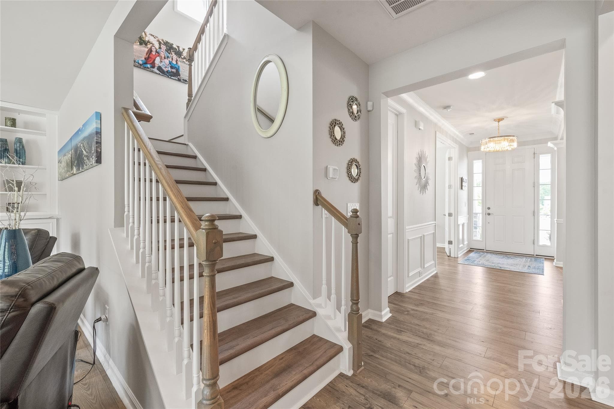 Featuring continuous LVP flooring, the staircase leads to a spacious second level boasting four well-appointed bedrooms. - 6440 Ancient Way, Fort Mill