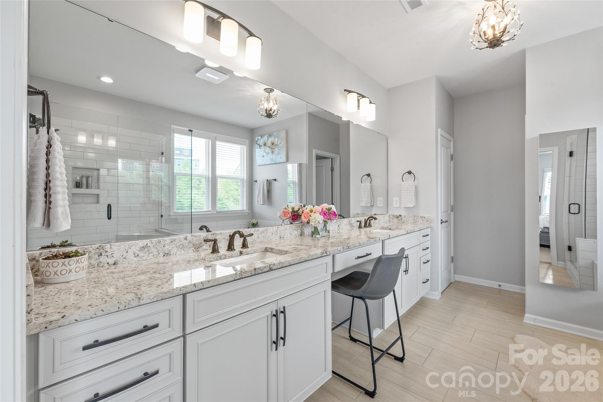 Dual vanities, sprawling countertops, and ample cabinetry make this primary ensuite as functional as it is beautiful. - 6440 Ancient Way, Fort Mill
