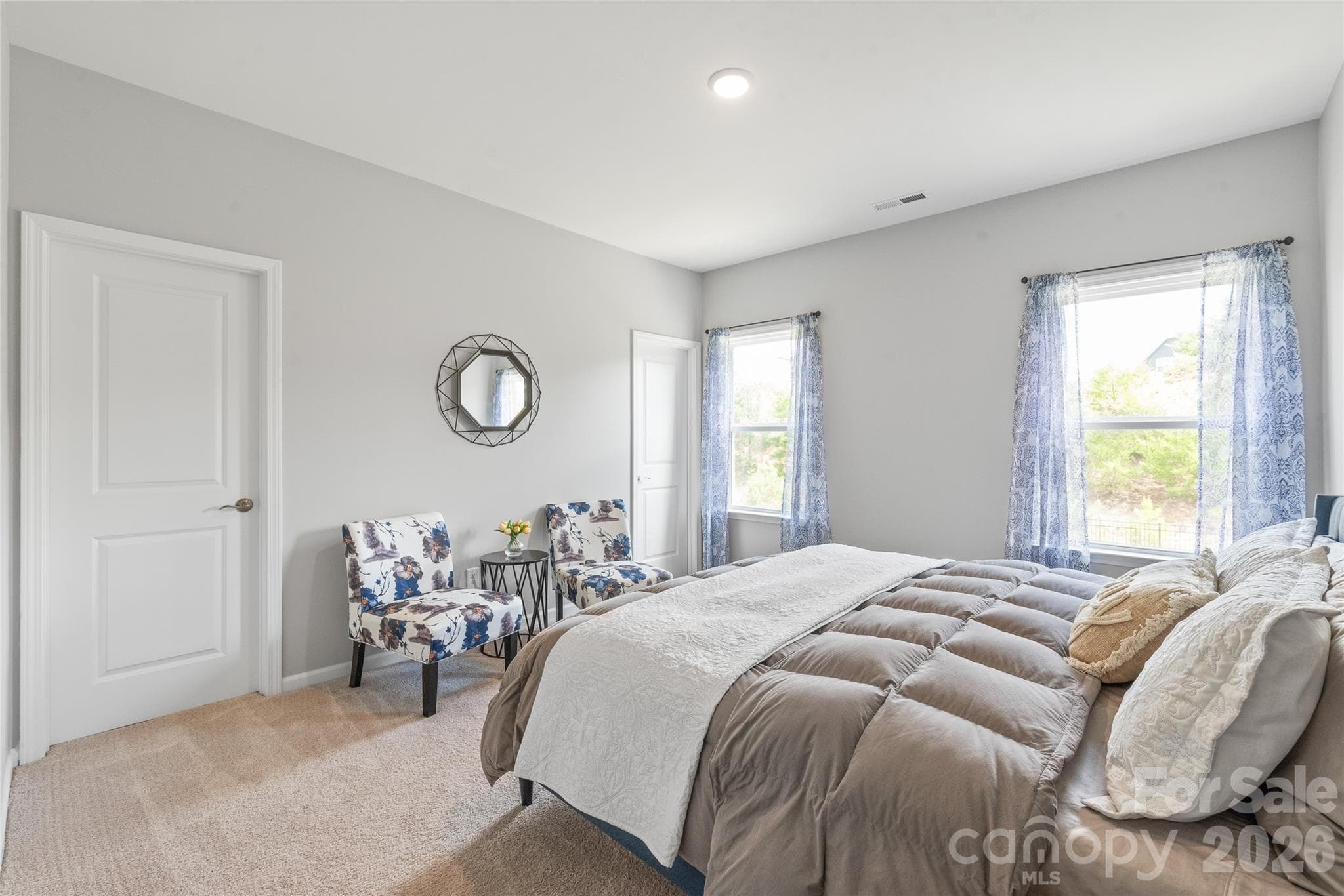 A spacious bedroom featuring a generous walk-in closet and direct access to a shared full bathroom. - 6440 Ancient Way, Fort Mill
