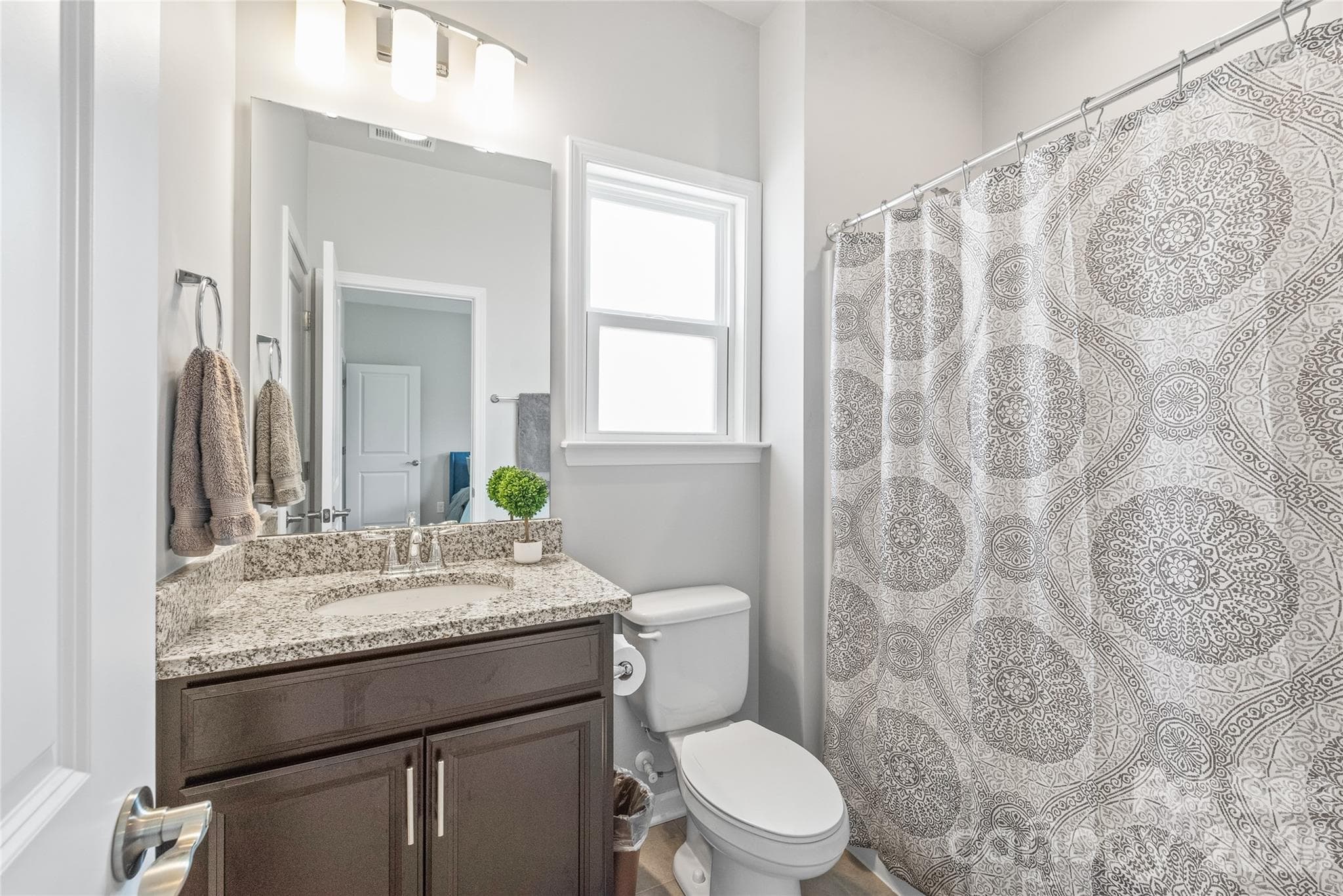 Serving both Bedroom 2 and the bonus room, this full bath delivers stylish finishes and seamless Jack-and-Jill accessibility. - 6440 Ancient Way, Fort Mill