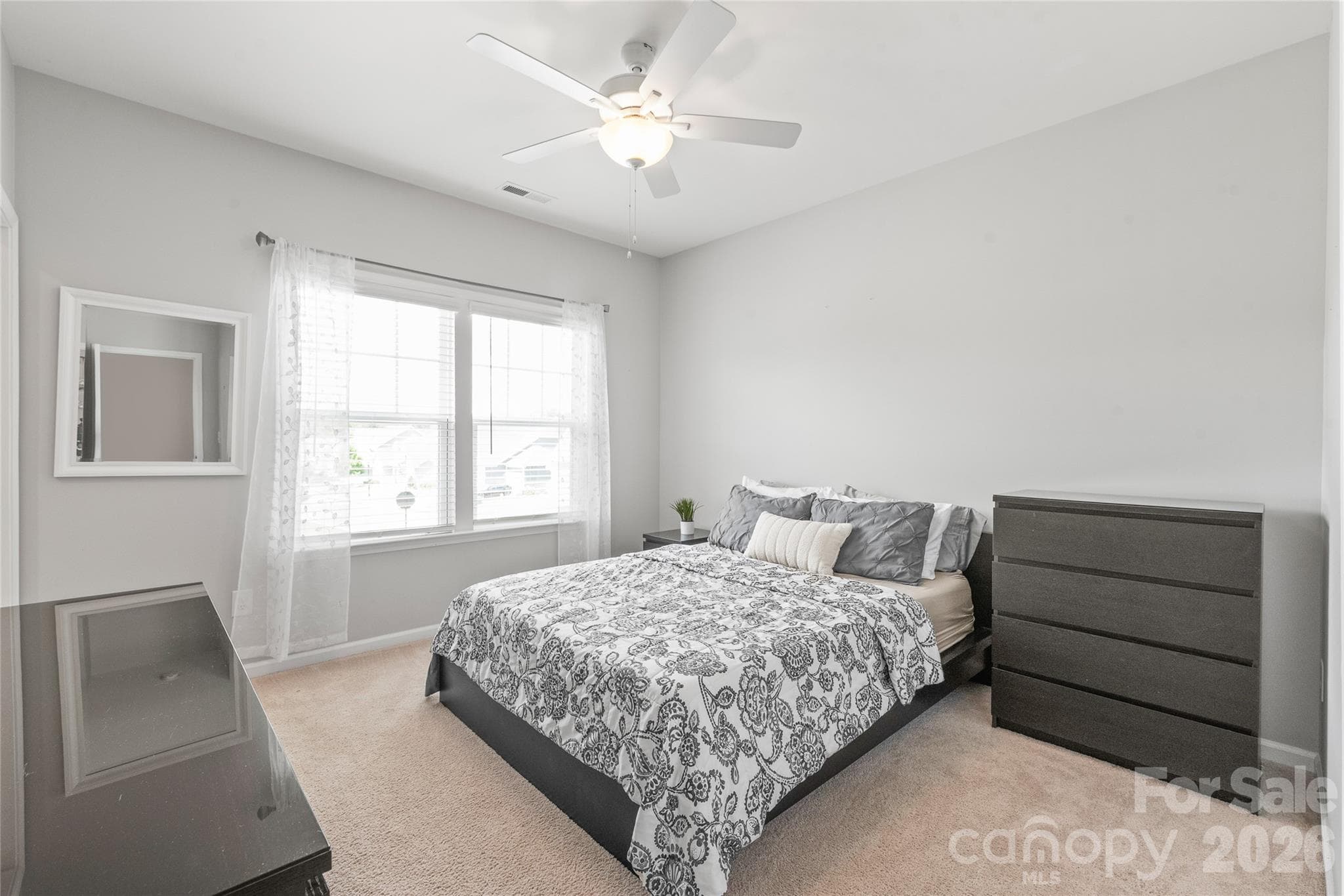 A spacious third bedroom offering a generous walk-in closet and seamless access to a shared Jack-and-Jill bathroom. - 6440 Ancient Way, Fort Mill
