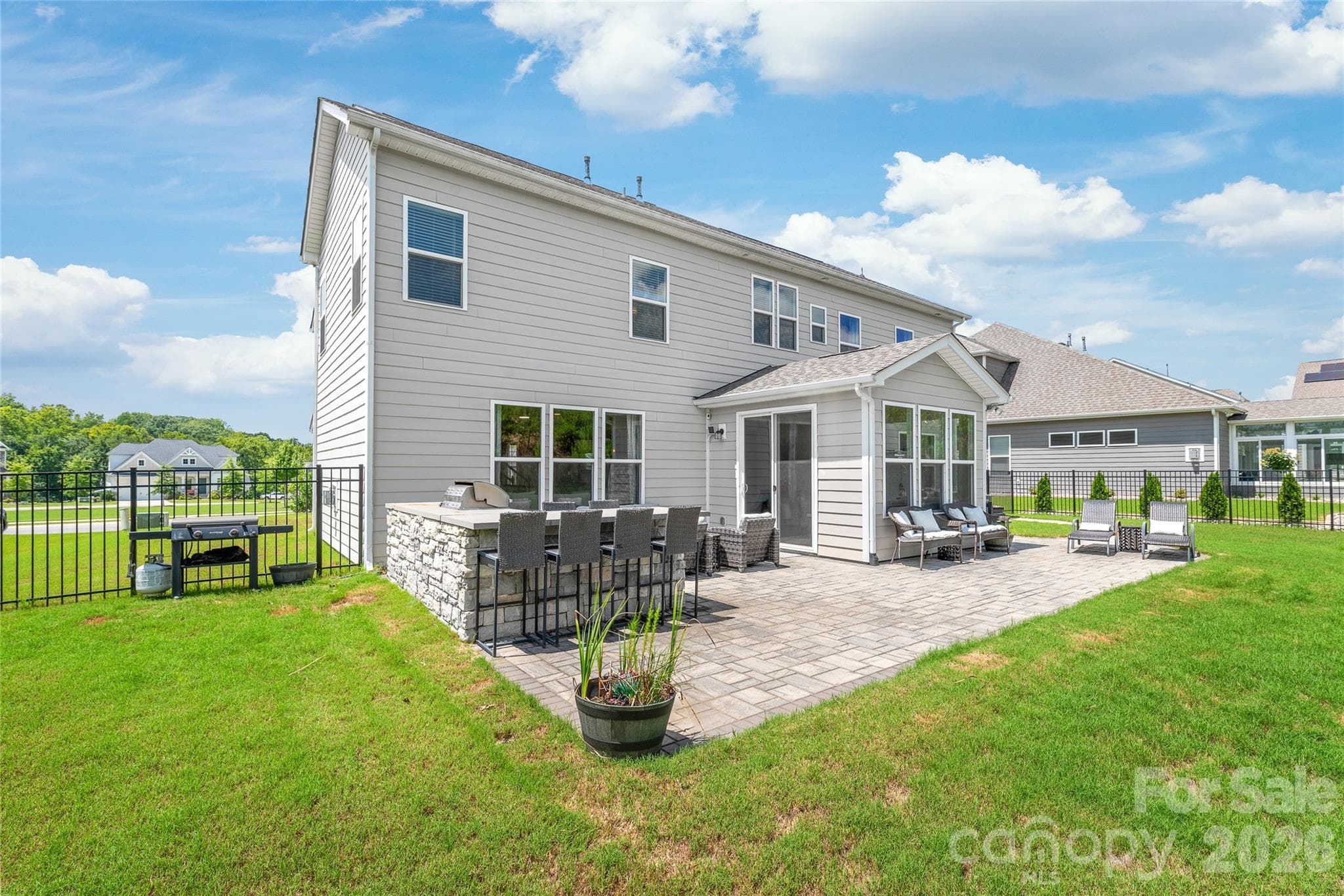Fire up the grill...complete with an outdoor kitchen and bar seating for easy outdoor entertaining. - 6440 Ancient Way, Fort Mill