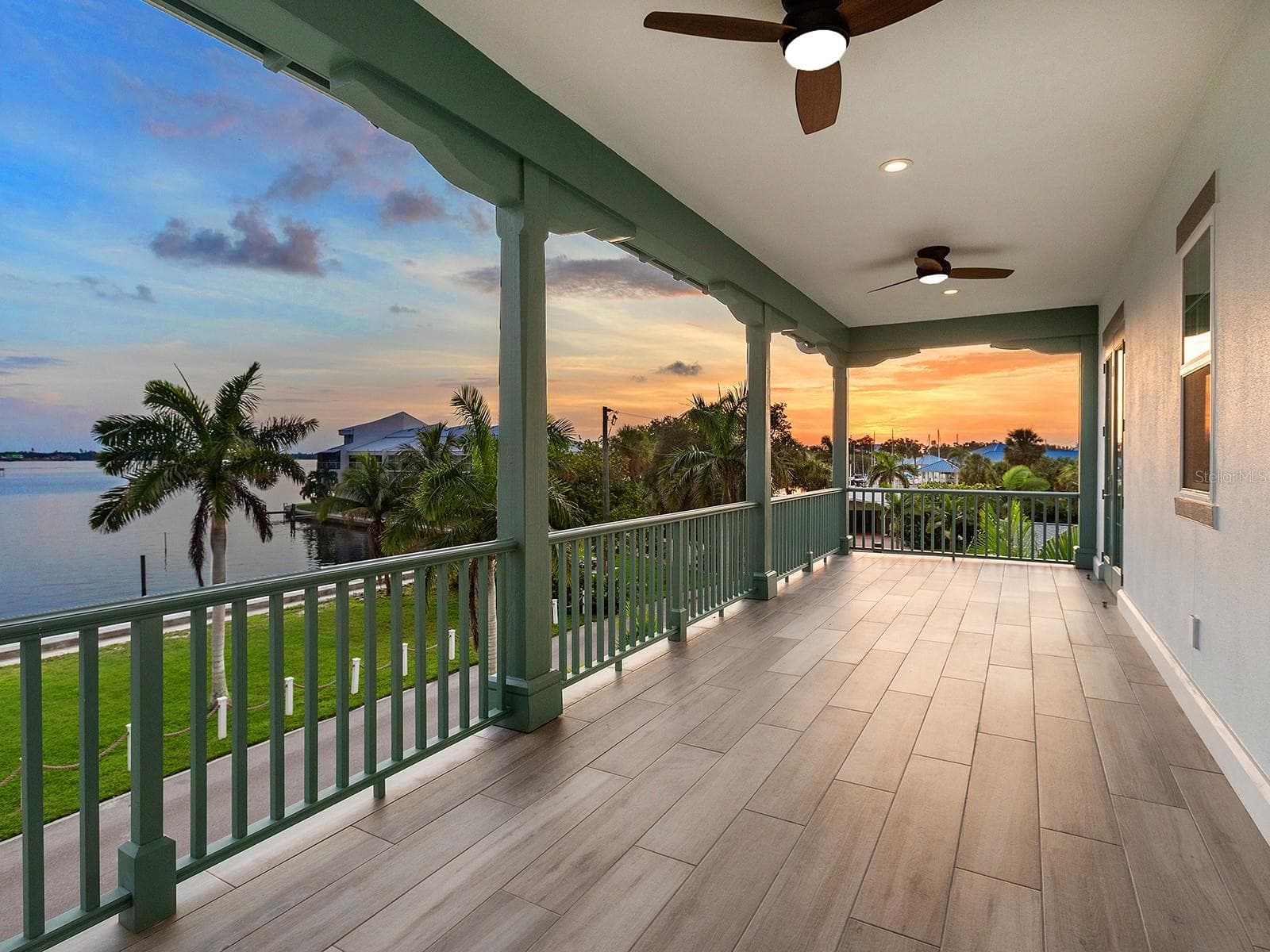 Second-floor primary suite balcony offering Manatee River sunset views - 4024 11TH STREET CT W, PALMETTO