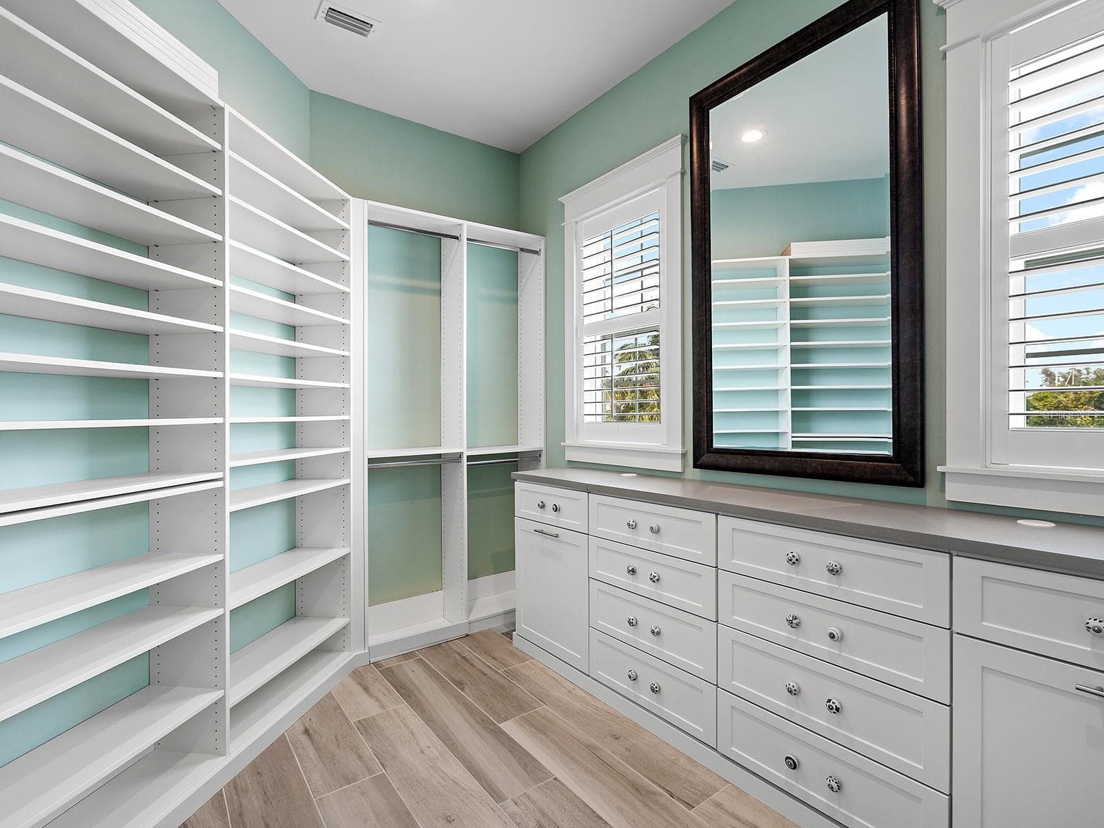 Spacious primary walk-in closet featuring custom built-ins and rich natural light - 4024 11TH STREET CT W, PALMETTO