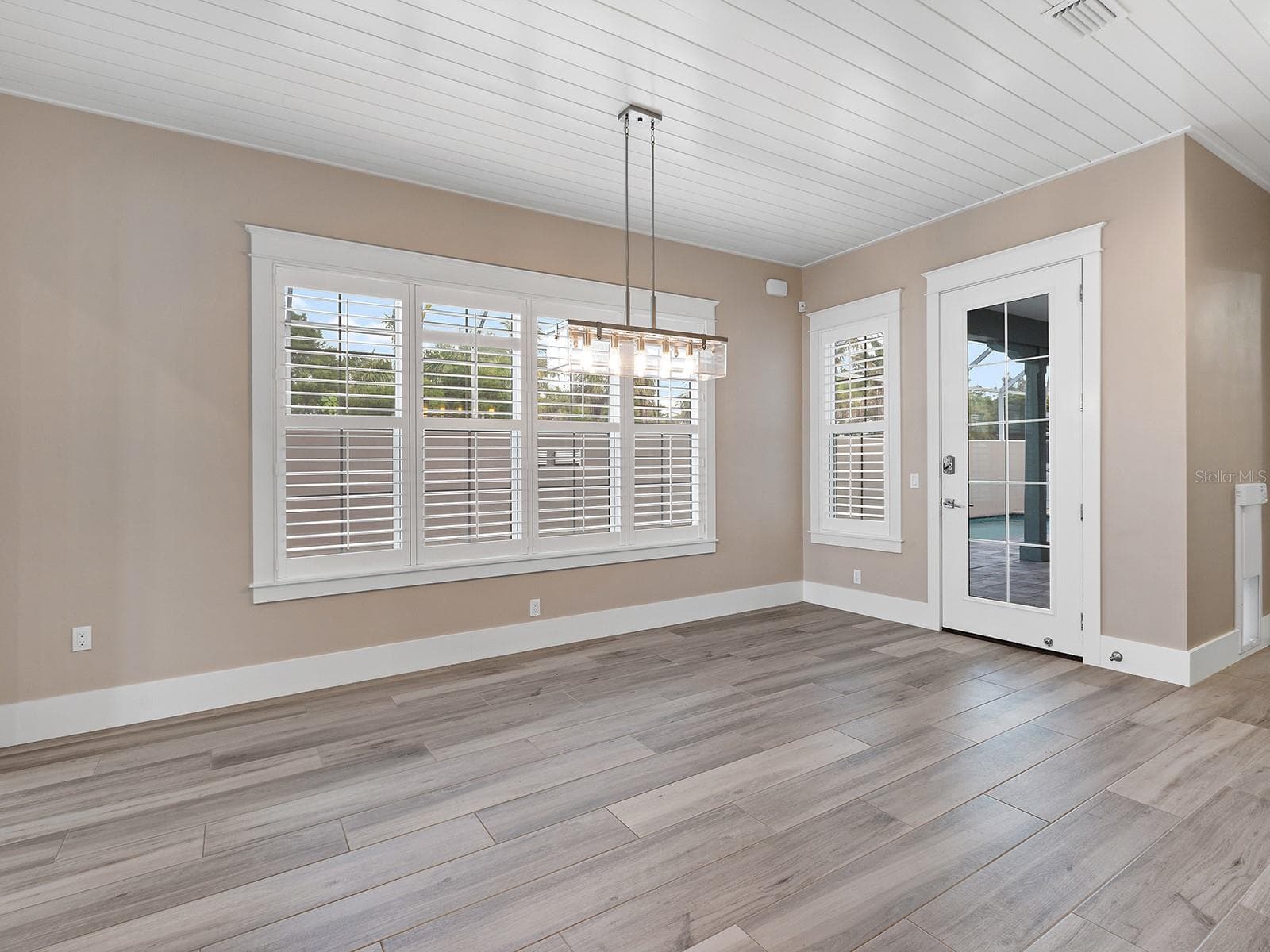 Dining space with a view of the expansive pool deck - 4024 11TH STREET CT W, PALMETTO