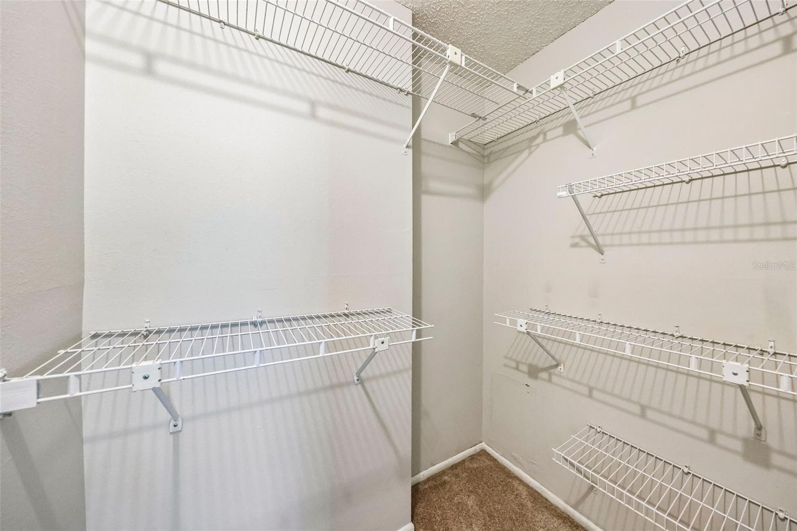 Primary bedroom walk-in closet. - 124 RESERVE CIR #100, OVIEDO