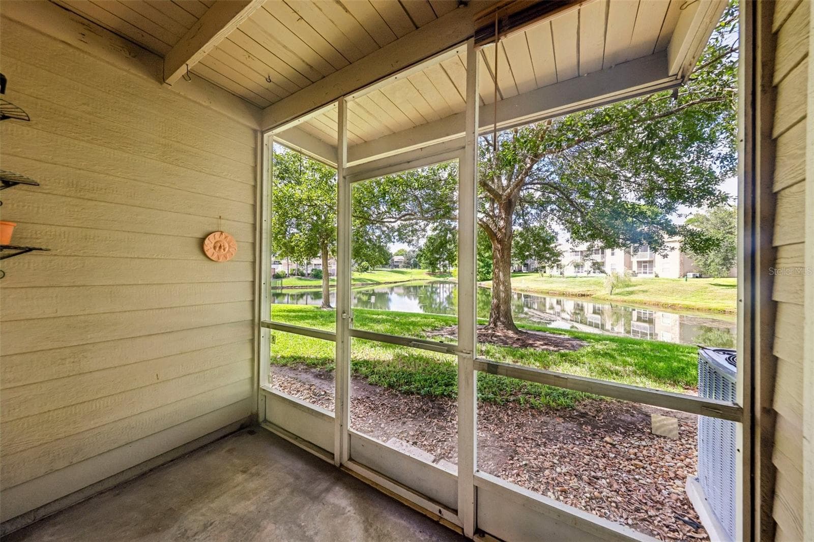 Screened lanai has pond views. - 124 RESERVE CIR #100, OVIEDO