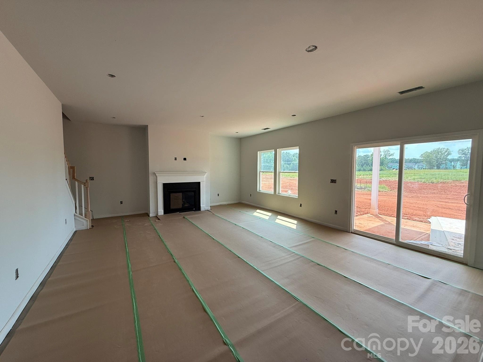 Spacious Family Room with Fireplace as well as covered rear patio can be seen - Charlotte