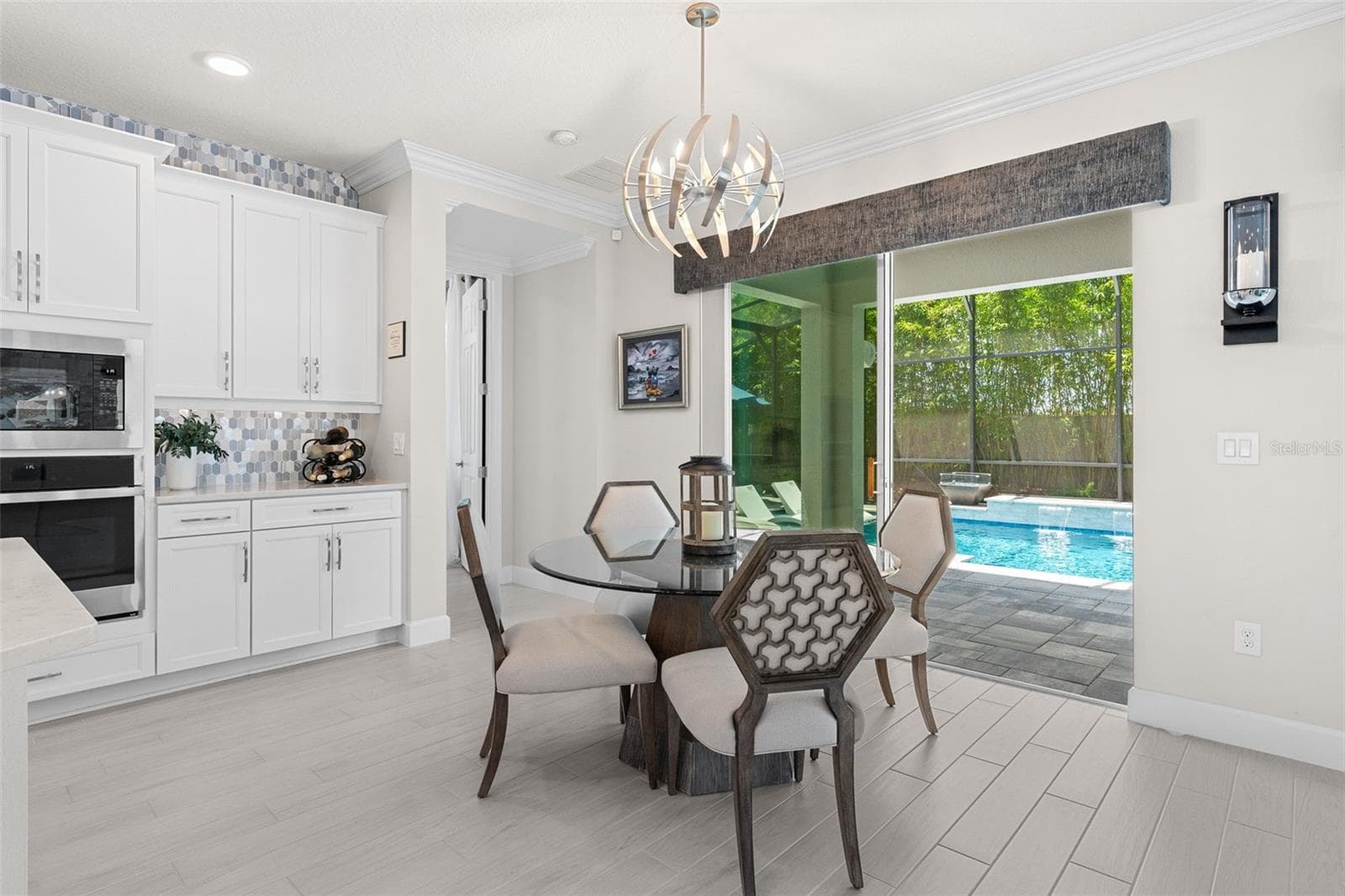 Casual dining with a view of the pool. - 3336 LONE CYPRESS PT, OVIEDO