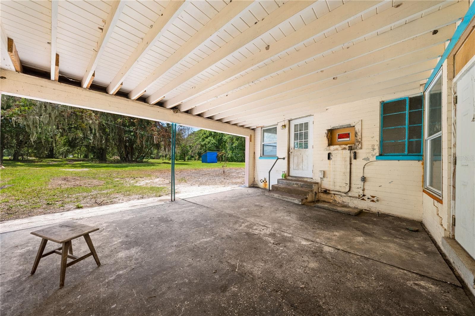 Carport with 2 bays attached to the home. - 2557 AMES HAVEN RD, KISSIMMEE