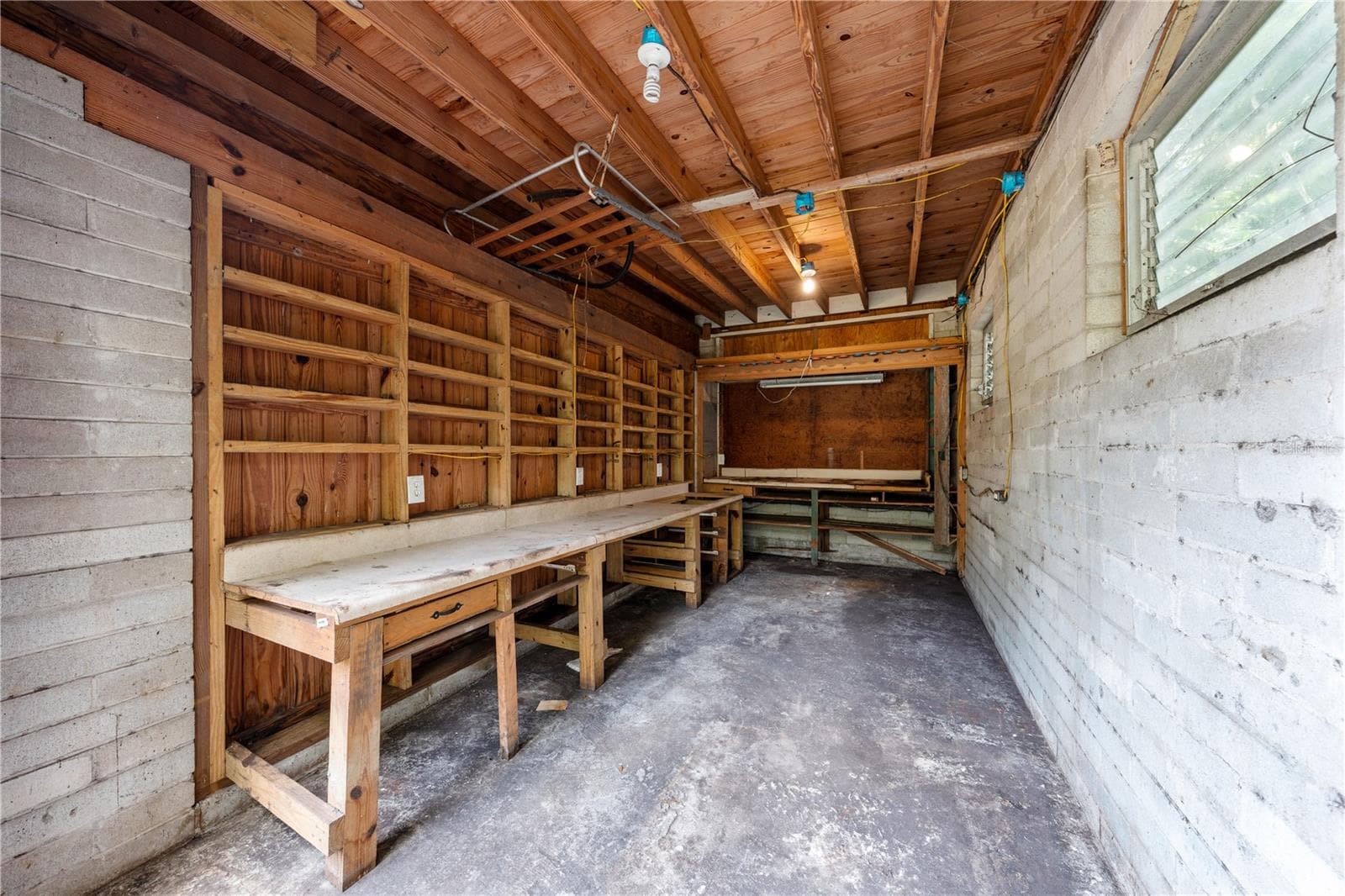 Storage area attached to the home on the right side of the carport. - 2557 AMES HAVEN RD, KISSIMMEE