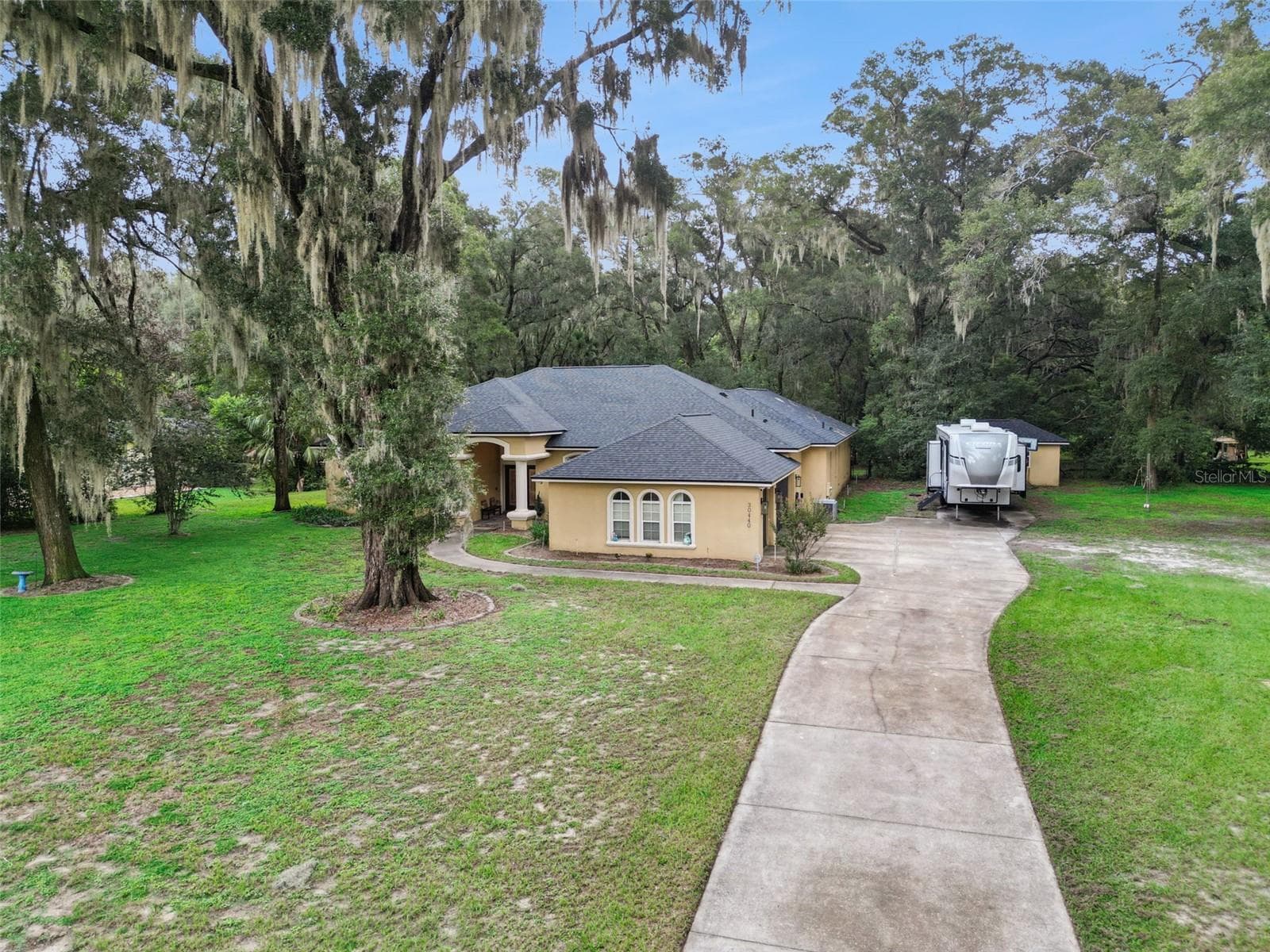 Aerial view highlights the home, circular-style drive approach and wooded country setting. - 30440 JUBILEE WAY, SORRENTO