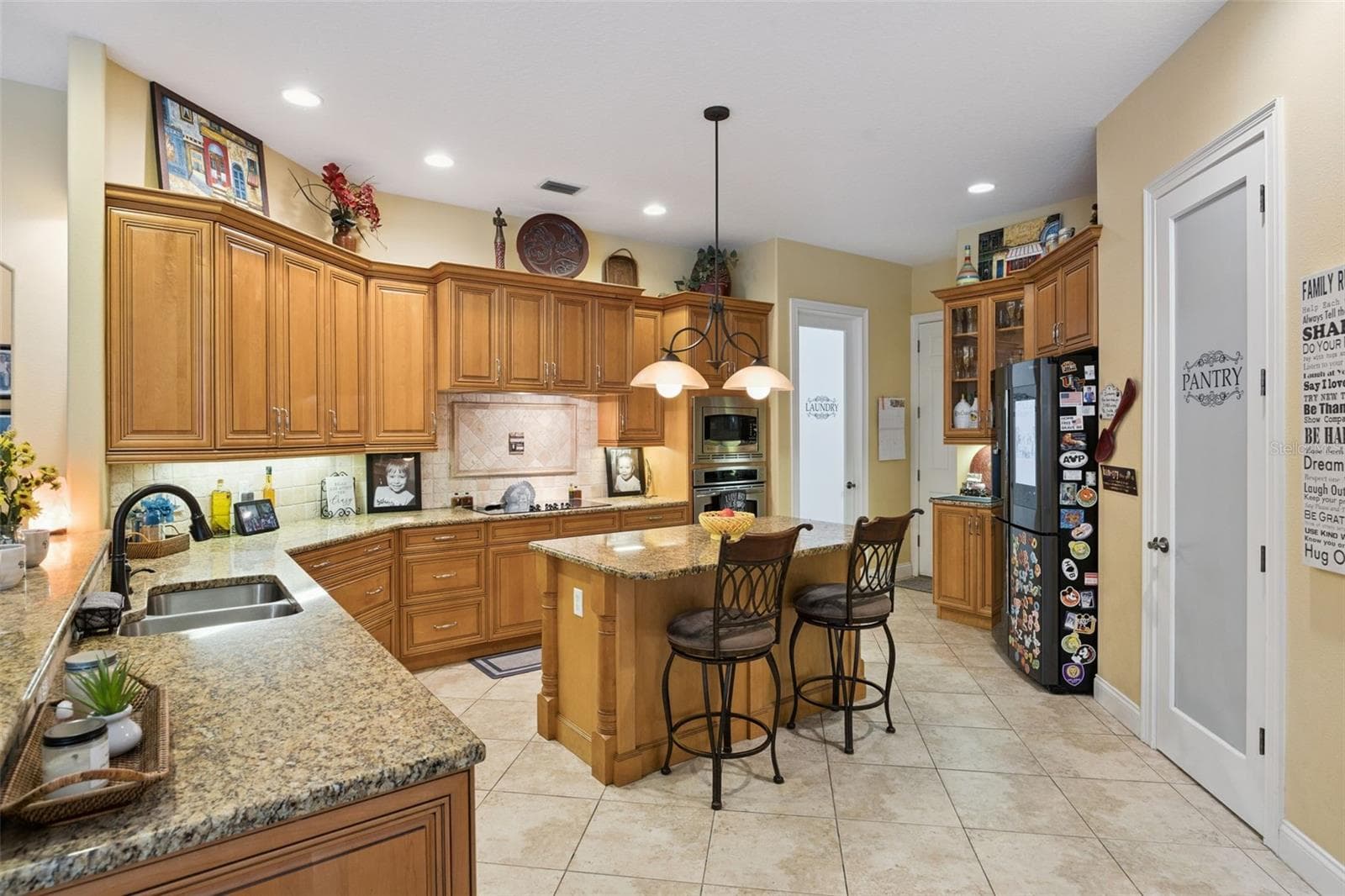 Updated kitchen with generous cabinetry, granite counters, island seating and abundant workspace. - 30440 JUBILEE WAY, SORRENTO