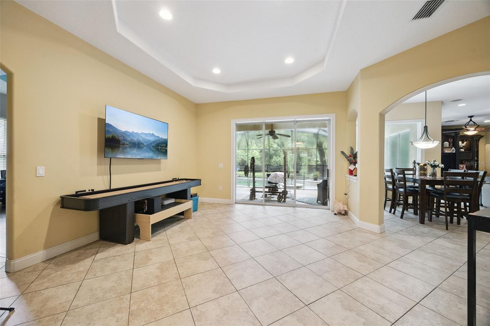 Living area opens directly toward the covered lanai and pool enclosure. - 30440 JUBILEE WAY, SORRENTO
