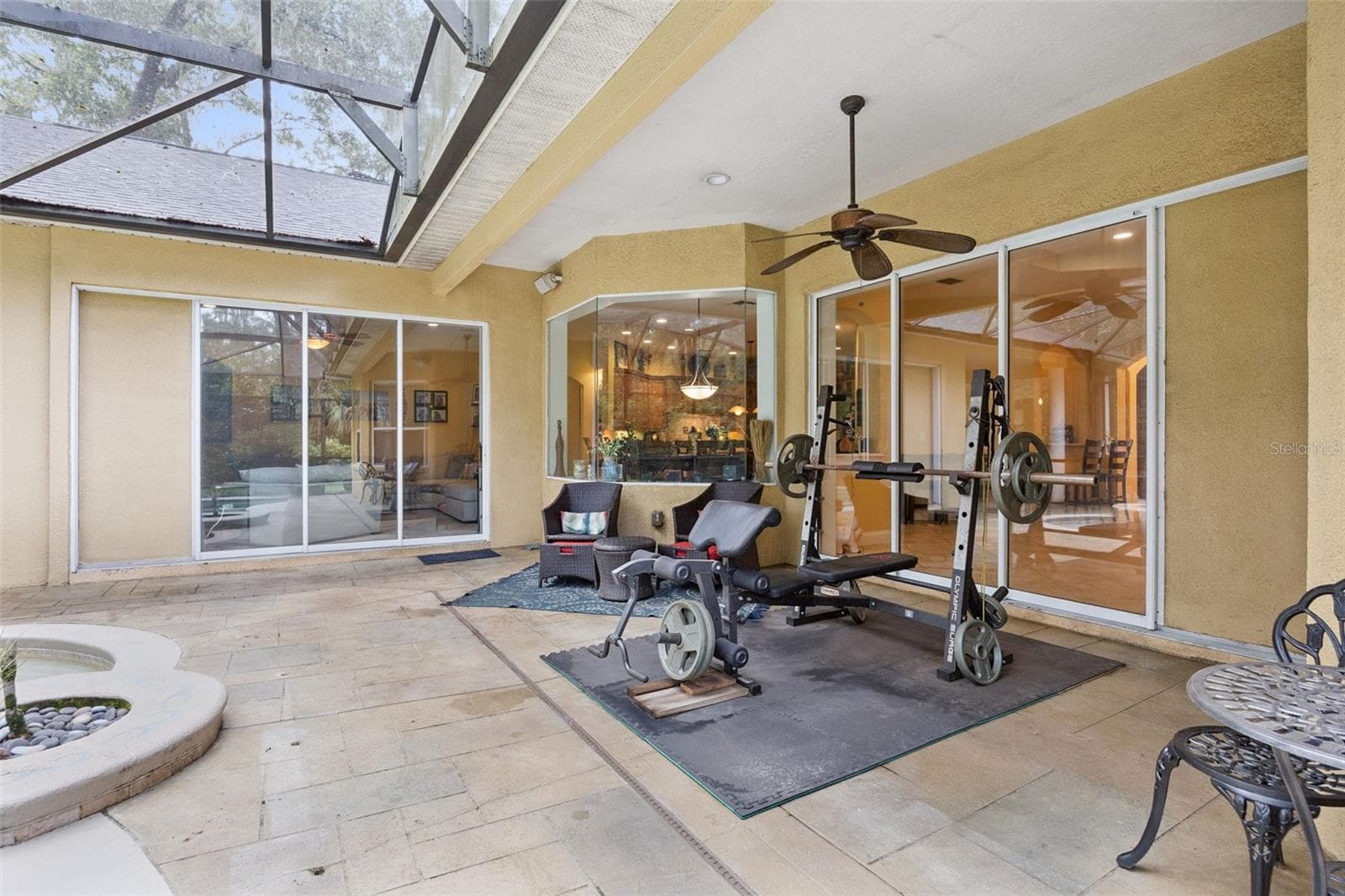 Large covered lanai offers substantial shaded space beside the screened pool. - 30440 JUBILEE WAY, SORRENTO
