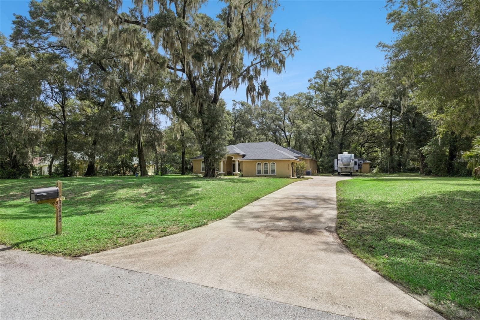 Long driveway and generous parking area lead to the home and three-car garage. - 30440 JUBILEE WAY, SORRENTO