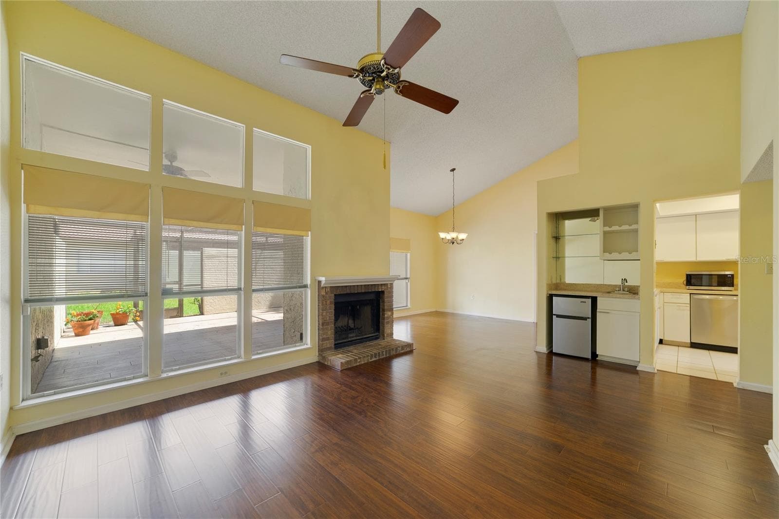 Living Room with Wood Burning Fireplace and Wet Bar with Refrigerator - 260 W SABAL PALM PL, LONGWOOD