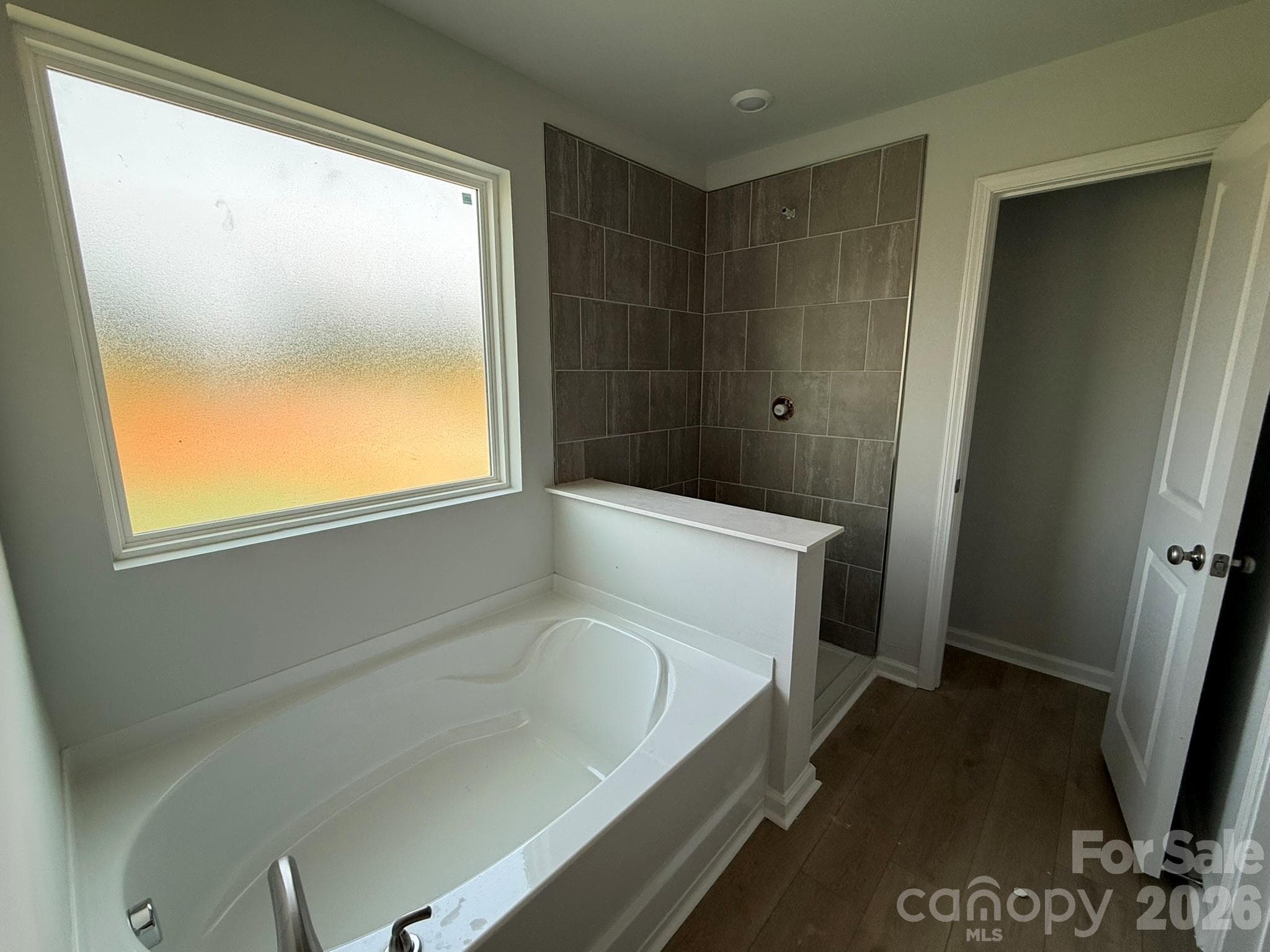 Garden tub and tile shower in Primary Bath - 1305 Bansal Drive, Charlotte