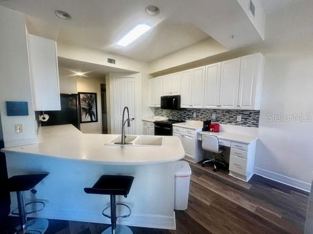 Stunning kitchen with ample cabinet space, breakfast bar, and decorative glass backsplash. New appliances with transferrable warranty until January 2029. - 98 VIVANTE BLVD #9834, PUNTA GORDA