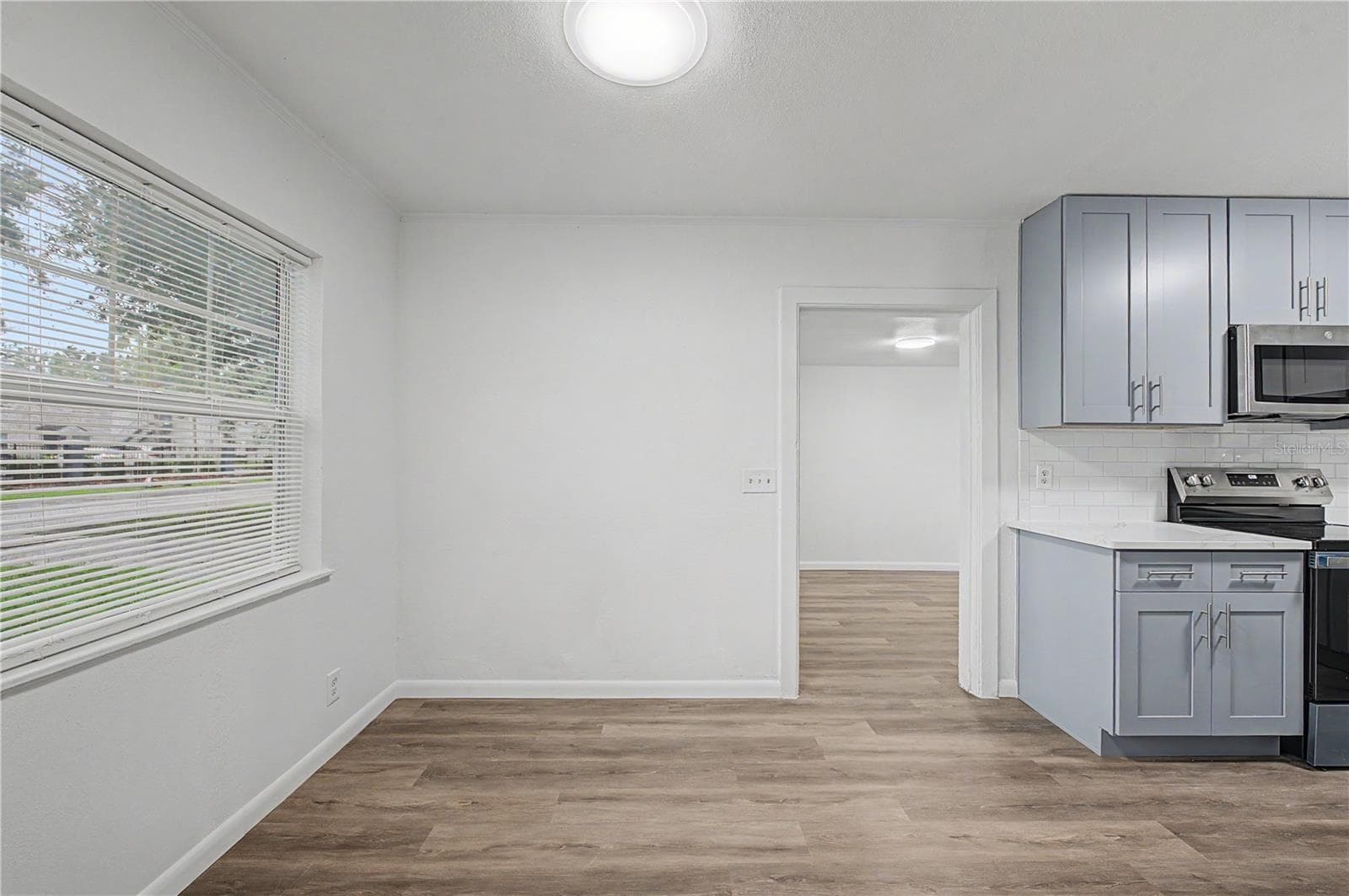 Dinette area, new flooring, blinds and light fixture. - 810 E 120TH AVE, TAMPA
