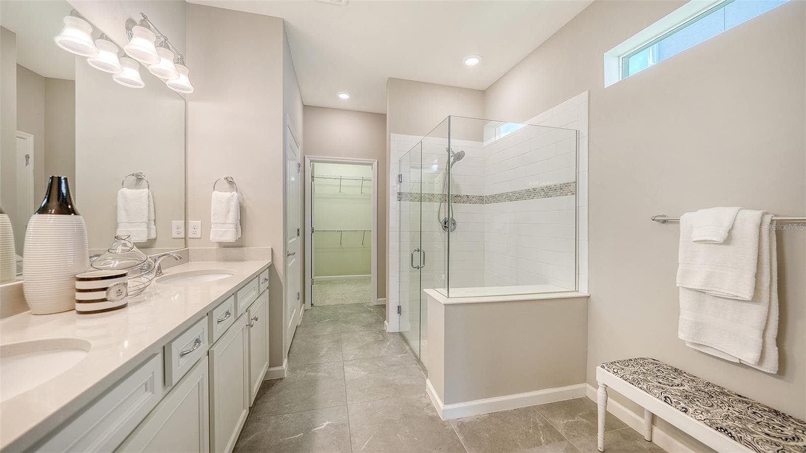 Primary Bath w/Dual Sinks, Step-In Shower, Frameless glass, and Listello Accent Tile - 3355 ANCHOR BAY TRL, BRADENTON