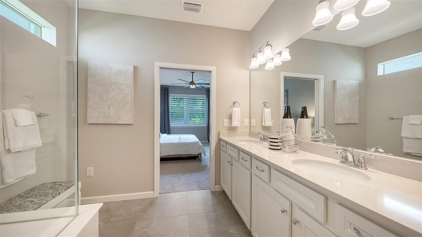 Primary Bath w/Dual Sinks, Step-In Shower, Frameless glass, and Listello Accent Tile - 3355 ANCHOR BAY TRL, BRADENTON