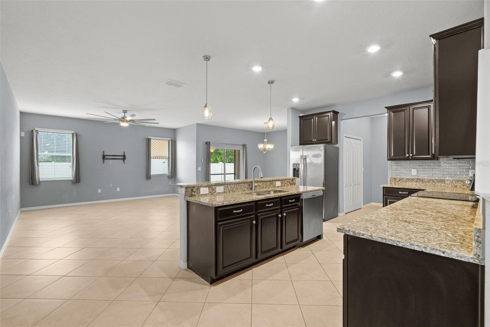 Kitchen & Living Area — Open-concept kitchen overlooks the spacious living and dining areas, creating an ideal layout for everyday living and entertaining. - 13728 REINDEER CIR, HUDSON